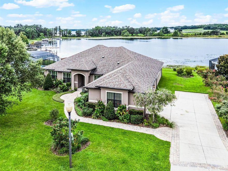 Come home to a quiet and peaceful setting directly on Little Lake Nellie.  The lake provides incredible sunset views and is great for fishing, skiing, jet skiing, and boating.  This custom home is built with attention to detail.  Home features trey ceiling with LED cove lighting and decorative panel molding, ceiling speakers, and custom drapery.  Also ceramic wood look Tile flooring and plantation shutters.  Custom kitchen cabinetry with pullout drawers.  Office features corner sliding french doors.   As you enter the front double doors, the open layout rewards you with expansive lakefront views from the great room, dining room, second bedroom and primary bedroom.    End your day relaxing with cool breezes from your large waterfront lanai.  Natural landscaping and lake irrigation welcome Florida native birds and butterflies.