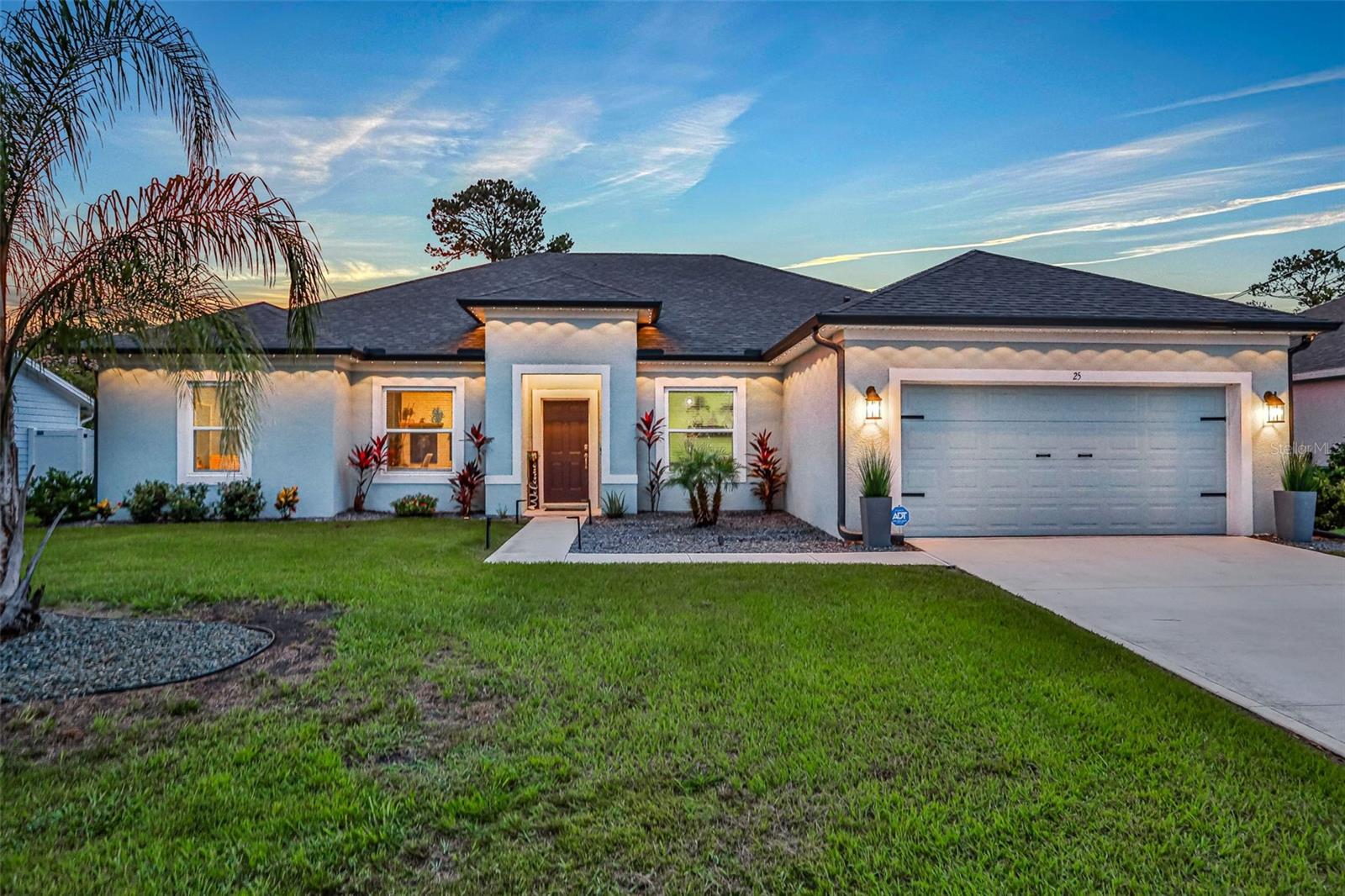 Welcome to your dream home, a stunning newly built and fully fenced haven with smart home features nestled in the tranquil Indian Trails neighborhood, where the perfect blend of luxury features and family living awaits. This spacious home with contemporary/modern interior design boasts a multitude of luxurious features within the 2,338 square feet. With 4 bedrooms, 3 full bathrooms and a dedicated office, this home is ready to inspire its new owners to love it as much as its current homeowners. As you walk through the home, you’re welcomed with a custom feature wall in the living room with a Carrera marble-styled slab and wooden slats making it a perfect statement piece. The kitchen has quartz counter tops with stainless steel appliances, gray 42" cabinets with lighting above, a large pantry, high-end gold and black kitchen faucet, and much more. The primary bedroom is a large size, along with a great size primary bathroom with a large walk-in closet. The other 2 bathrooms are great size and both have tubs while one has a door that leads right out to your back lanai This is the perfect haven for a growing family with a great open concept floor plan. This property has many features added inside and out, including gray seamless gutters around the entire home, a fully fenced back yard, a 6-zone irrigation system with a deep water well installed, high definition 1080p security cameras with night vision on all 4 corners with 2TB hard drive, an ADT security system installed including glass break detection, smart light switches that can be paired with Amazon Alexa or Google, a Ring security doorbell, cable cutout behind the TV to feed wires through for no visible wires in the living room from the TV to the entertainment system, exterior accent lighting on the front of the home which also can act as holiday lighting with hundreds of different lighting and light show combinations, and much more! Located only 1 mile from the newly built AdventHealth Hospital, close to shopping, restaurants, and Flagler County’s beautiful beaches. Massey has been paid through the year and into next year until April 2026 for lawn health and maintenance. A/C has been regularly maintained. Schedule your showing today.