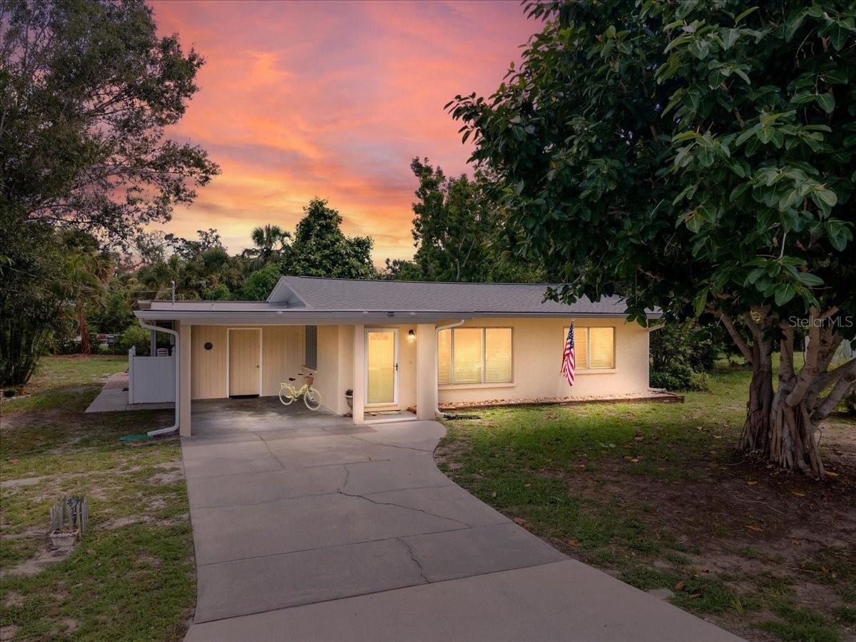 One or more photo(s) has been virtually staged. Welcome home to your piece of paradise only 1.3 miles from Nokomis Beach on Casey Key in a NO FLOOD ZONE! Ride your bike or walk to the beach and North Jetty. Enjoy swimming, fishing, watching the pelicans, manatee, dolphins and other ocean life. Adventure is waiting at the Clear Kayak Glass Bottom Tours on Casey Key. There is a kayak ramp and Jetty Rentals offering kayaks, paddle boards, surf boards and more. Even closer is the local Gulf Harbor Marina, famous Pop’s Sunset Grill and Pelican Alley Restaurant.
This wonderful Old Florida home incorporates yesteryear’s charm with up-to-date upgrades and even an unbelievable owner’s suite with home office addition. A treasured Banyan tree in the front yard welcomes you home. When you first enter this enchanting 2 bedroom 2 and ½ bath residence, you will be captivated by the old Florida charm. Beautiful Terrazzo flooring throughout the living area and first bedroom. A lovely chandelier hangs in the dining room. The fully equipped kitchen is accented with whimsical, hand painted tiles. The addition has all hurricane windows, a walk-in shower with designer tile and double-head shower, a huge his & hers walk-in closet, an office with solid wood built-ins, tastefully designed with porcelain planking throughout the suite. The lanai and patio allow for outdoor entertainment and for making memories. The back and side yards have matured fruit trees including mango, Meyer lemon, zapote, and a couple of orange trees. Relax in the Gulf breeze under the shade and beauty of the old Banyan trees, the oak, bamboo and the beautiful garden areas. There is even a clothesline in the backyard. At the back of the carport is a laundry room with storage, a toilet and sink. Your outdoor parties and gatherings have access to this restroom without entering the house. There is so much character everywhere you look. This home was very much loved by its owners. It will be a gift for many years to come for the new owners. For more than just a house, this beachside cottage has it all! Close to 3 major airports, shopping, restaurants, professional baseball parks and cultural events.