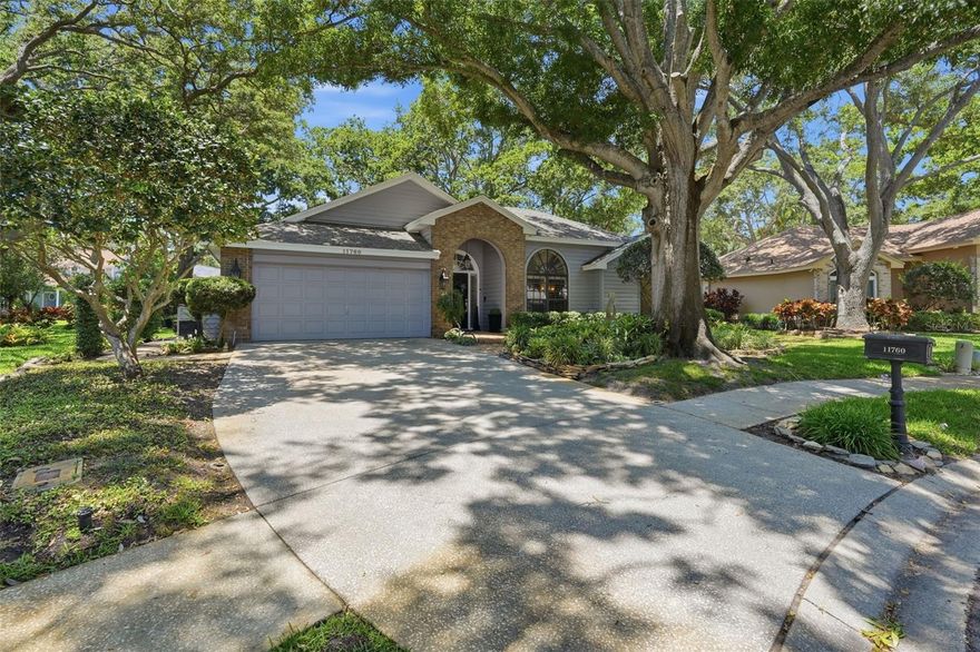 Words and pictures truly cannot do this spectacular property justice. From the moment you arrive, nestled on a private, oak-canopied cul-de-sac in the charming community of Quail Ridge, you are enveloped in pure serenity. This is a home that feels like a peaceful sanctuary—yet it sits just ten minutes from the sun-kissed Gulf beaches and steps from the scenic Pinellas Trail. Best of all, you can enjoy this paradise with total peace of mind, as the property sits securely in a non-flood zone. A true masterpiece of design, the home welcomes you with striking architectural details, elegant crown molding, custom wood shutters, and luxury vinyl flooring that flows effortlessly throughout. With over 2,250 square feet of sunlit, open-concept living space, the interior is perfectly designed for creating lifelong memories. Imagine cozy evenings by the fireplace, hosting family gatherings in the formal living and dining spaces, or preparing meals in the beautifully upgraded kitchen, complete with quartz countertops and premium new appliances. When you need to unwind, the private primary retreat offers a luxurious escape with a custom walk-in closet and a spa-like bath. Three additional spacious bedrooms ensure comfort for family and guests. Step outside into your own spectacular outdoor paradise. The grounds are designed for relaxation and entertainment, featuring a sprawling brick lanai, a tranquil sculpture garden, and a six-seater digital therapeutic spa made for stargazing. Complete with a large, parklike side yard just waiting for a future pool, this isn't just a house—it is the backdrop for your beautiful next chapter.