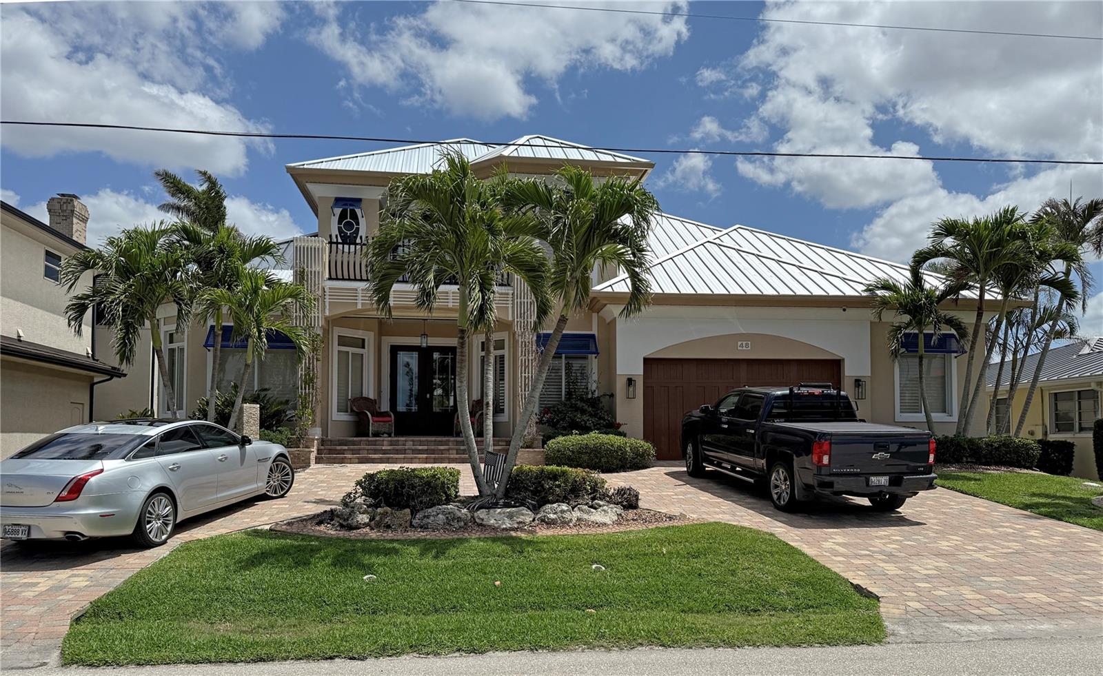 STUNNING WATERFRONT 3 Bedroom, Plus Loft/Bonus Room, 3.5 Bathroom home with attached oversized 2 Car Garage. Custom home built by Tim Towles located in desirable deed restricted Punta Gorda Isles. Fabulous location offers an immediate 2 minute access to Charlotte Harbor and on to the Gulf of Mexico. Full Harbor views from the front of the house and long water views of intersecting canals from the rear of the house with lots of boat traffic. This home offers beautiful upgraded design features throughout and an open and split bedroom floor plan with Great Room, separate Dining Room, well appointed Kitchen, Inside Laundry on the first floor. The Great Room features soaring ceilings, a gas (propane) fireplace and disappearing corner sliders to the lanai area and opens to the kitchen. The gorgeous Kitchen offers a breakfast bar, wood cabinets including pantry area with pullouts, stainless appliances, wine refrigerator, gas (propane) 5 burner range with hood, built in double oven and large dining area overlooking the pool and water. The Master Bedroom suite features lanai access via French doors, California closet and impressive private bathroom with dual Decolav semi recessed sinks, soaking tub and large walk in shower. The Inside Laundry can be accessed via the master closet OR the hallway. The Laundry offers front loading washer and dryer, cabinets and sink. There is a guest suite on the other side of the house that features lanai access and a private bathroom with walk in shower which is also a Pool Bath. There is also a large guest bedroom and full guest bathroom with large walk in shower on that side of the house. The second floor offers a large loft room which could be a bedroom, family room or office (currently used as an office) Full Harbor views from second floor and glass double doors lead to the balcony on second floor. On the first floor your living space extends via sliding glass doors to the screened lanai and pool area with heated inground pool with waterfall and heated spa, paver deck, summer kitchen with grill, hood, sink and refrigerator, outdoor shower, covered area and open deck for sunbathing. Continue on the paver walkway to the 80 foot concrete seawall (maintained by the city of Punta Gorda) concrete dock, 12,000 lb boat lift, 6000 lb boat lift and kayak lift. Awesome views of intersecting canals. Other features include double door entry, metal roof, lush tropical landscaping, circular driveway, tile and hardwood flooring, 2 zone A/C, IMPACT windows and sliders, city water and sewer. Two car garage offers large additional area for workbenches and storage. NO FLOODING from hurricanes Helen and Milton. Minutes from Fishermen's Village and historic downtown Punta Gorda shopping, dining, medical care, waterfront parks, fishing piers, walking and biking paths, Charlotte Harbor Event Center, art galleries , weekend farmer and artisan markets, downtown events and more!