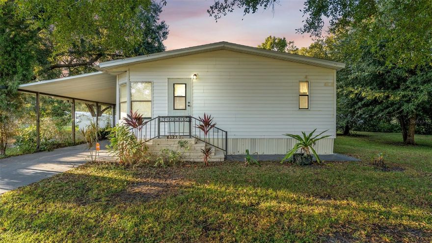 Adorable North Lakeland manufactured home! With some TLC, this property has lots of potential! New Water Heater 2022 and Roof was replaced 5 years ago. This spacious 3-bedroom, 2-bath double-wide, built in 1989, offers 1,512 sq. ft. of living space on a generous 0.26-acre lot with beautiful trees providing plenty of shade. Enjoy peace of mind—this property is not in a flood zone and has no HOA! Inside, you’ll find a large, bright sitting room filled with natural light from multiple windows, and a kitchen with ample cabinetry and included appliances—refrigerator, dishwasher, and oven. A washer and dryer are also included and conveniently located in their own laundry closet. The primary suite features an en-suite bathroom with dual sinks, a large soaking tub, and a separate walk-in shower with a built-in shower seat. Ceiling fans throughout add comfort, and double doors open to the backyard, offering great potential for outdoor enjoyment. A carport provides covered parking. Conveniently located just minutes from I-4 and US-98, shopping, dining, Walmart, Lowe’s, the mall, and Bonnet Springs Park—plus less than 40 miles to Disney and other major Central Florida attractions. This home has so much to enjoy! Seller is also offering a $15,000 credit towards carpet replacement, repairs,  buyer closing cost and or buy down.