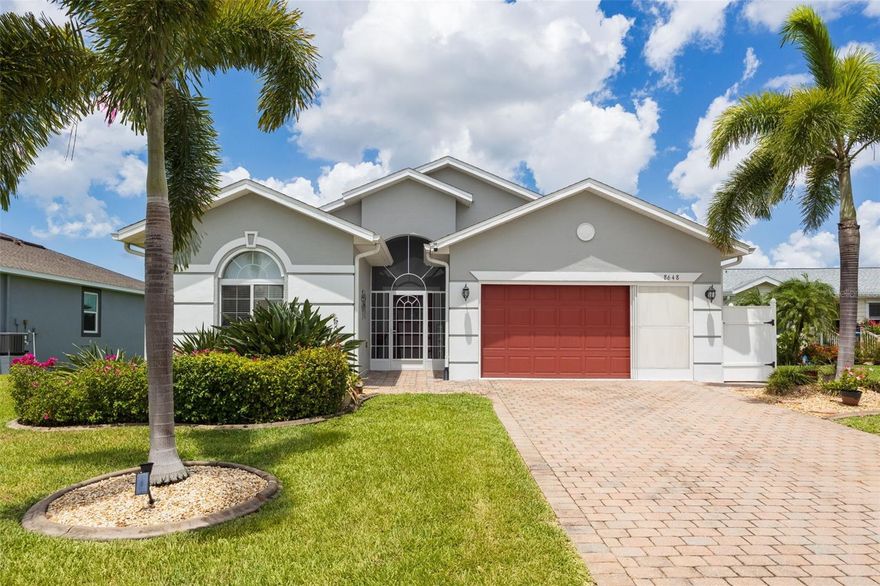 Welcome to easy Florida living in the desirable 55+ gated community of Rio Villa Lakes in Punta Gorda! With a low monthly HOA and a convenient location just minutes from downtown Punta Gorda’s charming shops, restaurants, and waterfront attractions, this beautifully maintained home offers the perfect blend of comfort, privacy, and peaceful lakefront views .An inviting open floor plan featuring a sunny great room and tile flooring throughout most of the home, with carpet reserved for the primary bedroom. The spacious kitchen offers a breakfast bar, pantry, and a newer LG refrigerator. Sliding glass doors lead to the lanai where you can relax and enjoy sparkling lake views along with the birds and wildlife that make this setting so special. The split-bedroom layout provides privacy for both owners and guests, with two guest bedrooms and a shared bathroom located toward the front of the home. The generously sized primary suite is tucked away at the back of the home and features two closets, including a walk-in closet, along with an ensuite bathroom complete with a dual sink vanity, soaking tub, separate shower, and linen closet. Additional features include a newer roof, fresh exterior paint, irrigation for the lawn, shutters for the windows, a screened front entryway, and a  garage door screen that allows you to enjoy the breeze while working or relaxing in the garage. Transferable flood insurance adds additional value and peace of mind. This move in ready home is nestled within a quaint, golf cart friendly community offering amenities including a pool, clubhouse, tennis, and pickleball courts. Come experience the beauty and lifestyle Rio Villa Lakes has to offer, you may just fall in love.