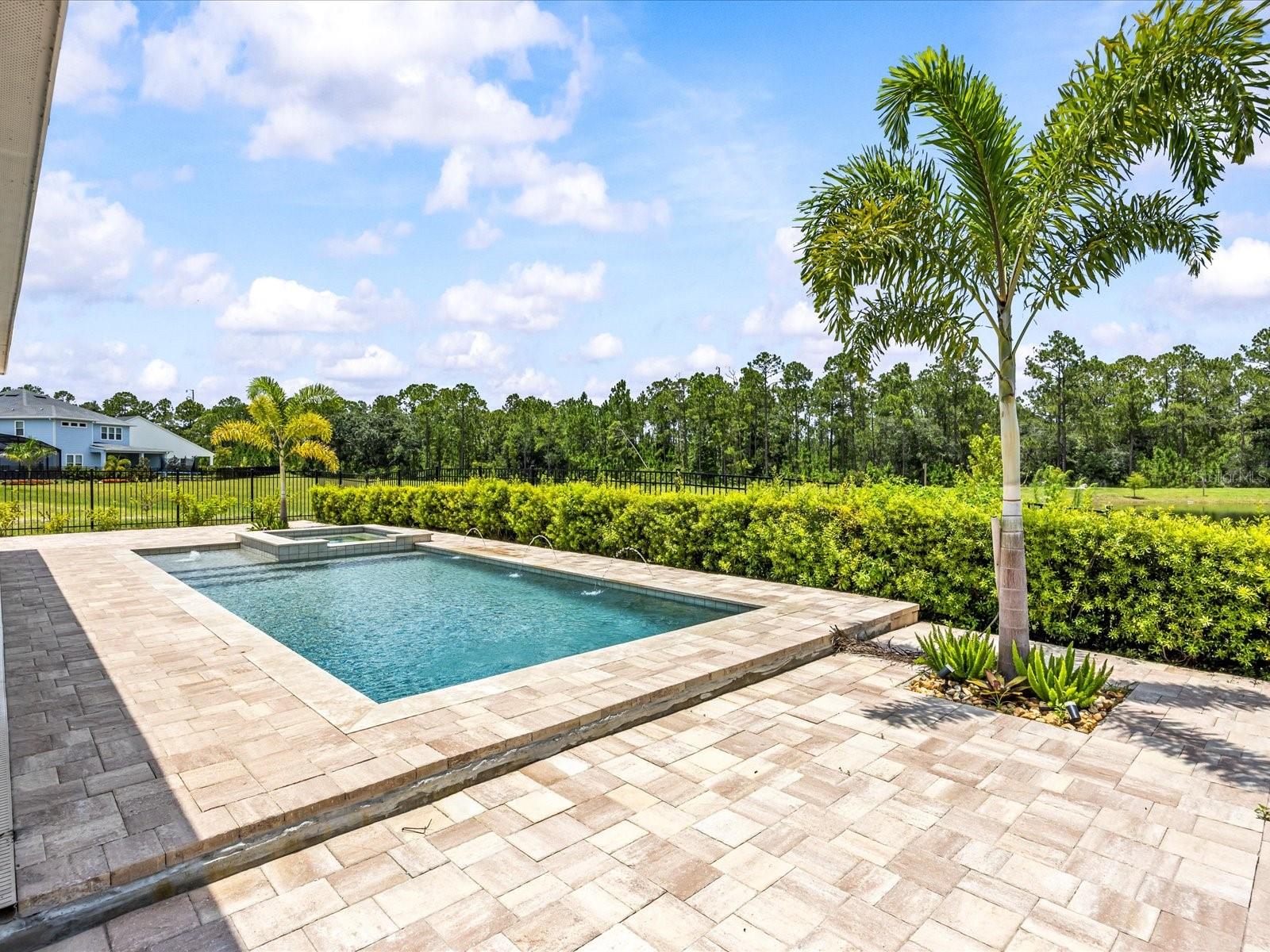 Why wait to build when you can own this rare, move-in ready gem?
Situated on an oversized corner lot with serene lake and conservation views, this stunning 4-bedroom, 2.5-bath pool home with spa is located in the highly sought-after community of Weslyn Park, part of the Sunbridge master plan.
Designed with wood-look tile flooring throughout and no carpet, this home offers a bright, open layout ideal for modern living. At the front of the home, two secondary bedrooms share a full bath, perfect for guests or family. At the heart of the home, there is a spacious great room and gourmet kitchen featuring an oversized quartz island, built-in oven, cooktop, upgraded stainless steel appliances, soft-close cabinetry, custom backsplash, and a walk-in pantry with built-in shelving.
A versatile flex room offers the perfect space for a home office or a fourth bedroom. The private primary suite is tucked away and offers a spa-like retreat with a freestanding soaking tub, walk-in shower, dual vanities, and a custom walk-in closet.
Step outside to your private backyard oasis; a covered lanai and expansive paver pool deck overlook lush landscaping, a fenced yard, and a pool and spa, with no rear or left-side neighbors for maximum privacy.
This is more than a home, it’s a lifestyle. Schedule your private showing of this one-of-a-kind pool home today!