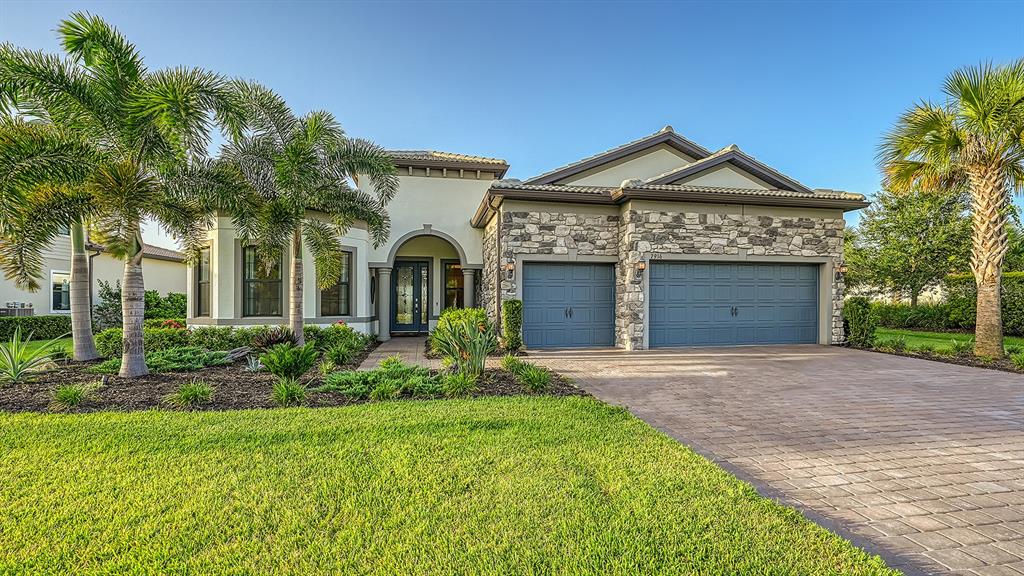 HUGE PRICE IMPROVEMENT! Say Hello to refined and relaxed lakefront living in this stunning luxury residence. Amazing, uninterrupted water view takes your breath away the moment you step in. Comfortable, open floor plan flows effortlessly and invites you to enjoy life to its fullest. The chef of the house will love the beautiful gourmet kitchen with high-end appliances, wine refrigerator large walk-in pantry, natural gas cooking, beautiful quartz countertops and premium diamond cabinets, all the way to the ceilings. Living area features dramatic coffered ceilings, state of the art fan with cutting-edge smart technology and opens through sets of stackable glass doors (all hurricane proof windows and doors) to the outside living space. Amazing, custom designed, summer kitchen features Alfresco 36" natural gas grill with built-in Smoker and Rotisserie and Alfresco 24" Versa Burner/Griddle/Wok and a beautiful LED fireplace. Relax with a drink in your custom designed, salt water, heated pool with a spa, overlooking peaceful private water views and tropical sunrises and sunsets. Master bedroom retreat has the same beautiful water views and a luxurious bathroom with an enormous walk-in closet. This is smart home with voice-controlled lights, fans, front door lock, pool, Sonos speakers system. Please ask for the complete list of features and upgrades. The location and the walkability within this sought-after, brand-new Sarasota community, cannot be more perfect. A discrete path to right of the back yard is an alternate way to walk to the resort style amenities, including community pool and spa, coastal inspired club house with catering kitchen, state-of-the art fitness center, kayak launch, tennis and pickleball, multipurpose turf lawn, outdoor bar, firepit, barbecue grills and beach area with hammocks. You can also walk to the brand-new Waterside Town Center with a colorful Farmer's Market every Sunday and a variety of dining and boutique shopping options. Waterside at Lakewood Ranch is the hottest Sarasota address featuring scenic lakes, totaling 144 acres and beautifully landscaped preserves and parks.