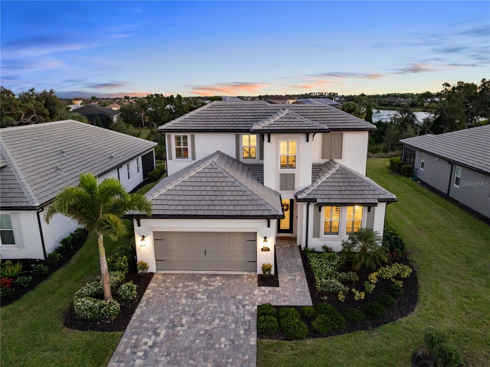 Luxury meets Elegance. Prepare to be captivated by this custom-designed, energy-efficient masterpiece located in the highly desirable Sweetwater community of Lakewood Ranch! This magnificent 4-bedroom, 3-bathroom home isn't just a place to live; it's a statement of style and comfort, perfectly positioned on a premium, oversized lot with NO REAR NEIGHBOR—guaranteeing exceptional peace and privacy.
Step inside and be instantly charmed by the architectural details. The showstopping custom black iron staircase is a true work of art, complemented by exquisite upgraded trim and millwork that flows throughout the home. The heart of this residence is a chef’s dream kitchen, featuring dazzling quartz countertops and rich 42-inch shaker cabinetry, providing a perfect backdrop for entertaining. A downstairs guest bedroom and full bathroom offer ideal multi-generational living flexibility. The main living area is further enhanced by chic accent walls, adding a pop of designer style!
The flexible layout is ideal for modern living, including a dedicated office/den with elegant French doors, offering a quiet space for focus. Retreat to the luxurious primary suite, a sanctuary redefined by custom built-in cabinetry that ingeniously transforms part of the space into a versatile living area or home office nook, complete with a charming built-in bookcase. Upstairs, you will find 2 generous bedrooms surrounding a massive bonus/entertainment area and a dedicated office nook, providing endless possibilities for play, study, or media.
Every window in the home is framed by gorgeous Plantation shutters, adding timeless sophistication and light control. Get ready to create the ultimate Florida lifestyle! The backyard is prepped for paradise with an 80-amp in-ground pool & spa pre-wire and a dedicated control switch. Plus, you have the convenience of a gas drop for your pool/spa equipment and a separate gas drop on the lanai—perfect for a deluxe outdoor kitchen! Enjoy incredible year-round comfort and dramatically lower utility bills thanks to spray foam insulation throughout and a premium, recently installed (9/2025) upgraded air handler and external AC unit. The colossal oversized garage features a 4-foot extension, providing endless possibilities for a home gym, workshop, or abundant storage.
Location, location, location! You'll be zoned for the brand-new Lakewood Ranch K–8 school and have access to the first-class amenities of Sweetwater, including a resort-style heated pool, playground, pump track, multi-purpose sport court, pickleball courts, a state-of-the-art 24-hour fitness room, and a fantastic social space. This is more than a home; it's an elevated lifestyle waiting for you!