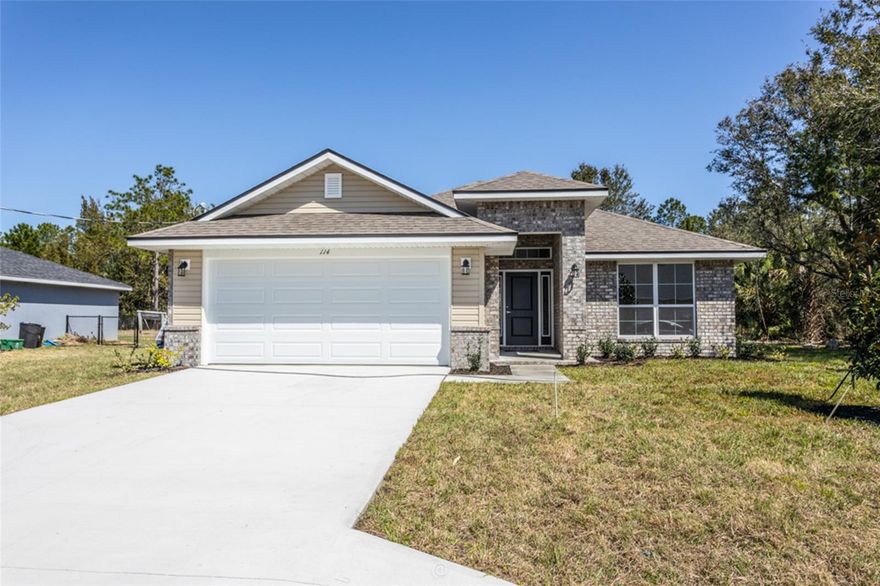 Under Construction. This 1820 sqft brick home in the Pine Lakes area of Palm Coast is a 4-bed, 2-bath beauty is just minutes from beaches, shopping, schools, and restaurants. Imagine this home having high ceilings, a formal dining room, and a spacious great room to create a vision of modern living and everyday comfort. Smart features like stainless steel Whirlpool appliances, energy-efficient double-pane windows with easy-clean fold-in design and a built-in Pest Home Defense system show the value of a thoughtful design. The owner’s suite sets the example of luxury, with a large walk-in closet, ceiling fan, and a spa-like bath featuring double sinks and sleek MOEN nickel faucets. Enjoy a covered back patio, extending your living space outdoors — perfect for morning coffee, evening gatherings, or quiet moments of relaxation. With warranties that protect your investment (1-year builder, 2-year mechanical, 10-year structural), you can truly own peace of mind along with your dream home. This home isn’t just built — it’s designed to bring your vision to life, teach the value of smart living, set the example for comfort, and give you the chance to own it all. $1,000 escrow deposit and when using one of our lender partners, we will pay a portion of closing costs. Saving thousands of dollars at the closing table. Photos are not of home