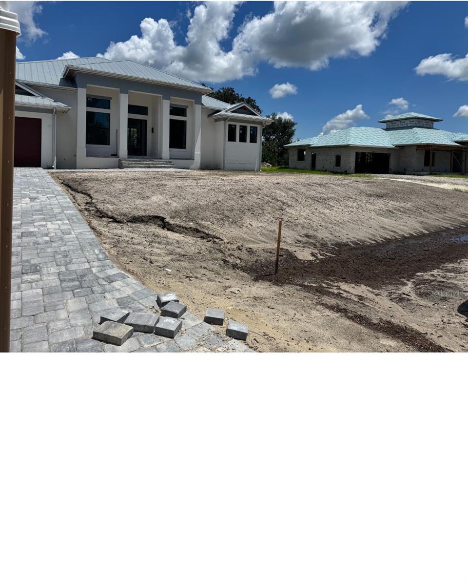 Under Construction. Completion by end of September! New construction nestled in the heart of Placida! Placida is a highly desirable waterfront community just over the bridge from the legendary town of Boca Grande. This inviting coastal retreat offers a serene escape with a touch of Florida's natural beauty. This charming single-family pool home with a 3-car garage has an open-concept living area that's bathed in natural light from the two large walls of pocketing glass in the great room and dining room. The kitchen will feature modern Thermador Appliances, an oversized waterfall island, and expansive quartz counters, making it a chef’s and entertainer’s delight Step outside to your covered lanai and outdoor kitchen, and you and your friends can enjoy the Heated Salt Water pool with an infinity edge hot tub. The luxurious primary suite pampers the homeowner with two walk-in closets, two vanities, a large tub, and a shower. This home will also have two additional en-suite bedrooms as well as a study, utility room, and wet bar. To top it off, essential Hurricane safety features like a Hurricane screen for the patio, impact-resistant windows and doors, an aluminum roof, and spray foam installation will be integrated to ensure your peace of mind and comfort. Placida is renowned for its charming coastal lifestyle, with access to boating, incredible fishing, and many other outdoor adventures. Explore nearby historic Boca Grande, known for its quaint shops, dining, and stunning beaches. This property is an excellent choice for those seeking a peaceful retreat or an active, outdoor-oriented lifestyle. Don't miss the opportunity to make this coastal gem your home. This property combines the best of coastal living with modern comforts, making it an ideal place to create lasting memories.