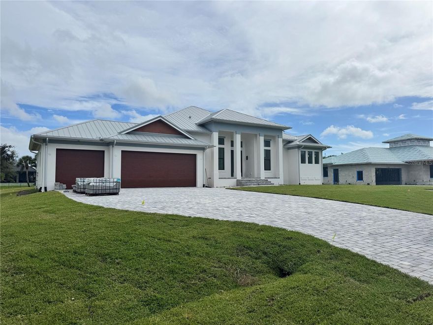 Under Construction. Completion by end of September! New construction nestled in the heart of Placida! Placida is a highly desirable waterfront community just over the bridge from the legendary town of Boca Grande. This inviting coastal retreat offers a serene escape with a touch of Florida's natural beauty. This charming single-family pool home with a 3-car garage has an open-concept living area that's bathed in natural light from the two large walls of pocketing glass in the great room and dining room. The kitchen will feature modern Thermador Appliances, an oversized waterfall island, and expansive quartz counters, making it a chef’s and entertainer’s delight Step outside to your covered lanai and outdoor kitchen, and you and your friends can enjoy the Heated Salt Water pool with an infinity edge hot tub. The luxurious primary suite pampers the homeowner with two walk-in closets, two vanities, a large tub, and a shower. This home will also have two additional en-suite bedrooms as well as a study, utility room, and wet bar. To top it off, essential Hurricane safety features like a Hurricane screen for the patio, impact-resistant windows and doors, an aluminum roof, and spray foam installation will be integrated to ensure your peace of mind and comfort. Placida is renowned for its charming coastal lifestyle, with access to boating, incredible fishing, and many other outdoor adventures. Explore nearby historic Boca Grande, known for its quaint shops, dining, and stunning beaches. This property is an excellent choice for those seeking a peaceful retreat or an active, outdoor-oriented lifestyle. Don't miss the opportunity to make this coastal gem your home. This property combines the best of coastal living with modern comforts, making it an ideal place to create lasting memories.