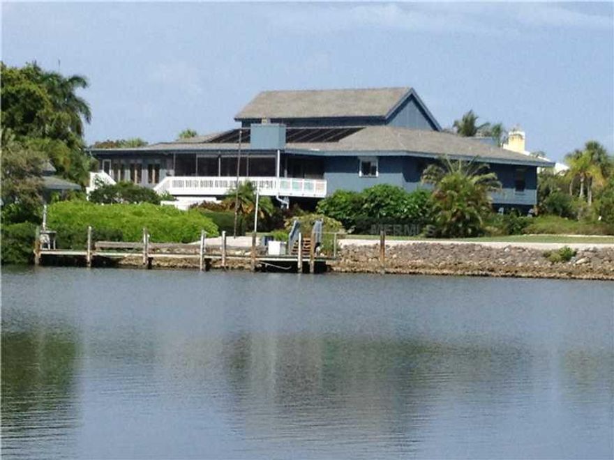 One of the two largest properties in Boca Grande Isles. This favorite Isles location offers 250' of deepwater front with excellent, protected dockage and is known by many as "The Isles home that had that beautiful, regulation putting green" for so many years!  While easily livable "As-Is" and in excellent condition with 4,300 square feet of one level, high ceilings living space ... the home could become a RENOVATED MASTERPIECE!  The floorplan encompasses 3 bedrooms and 3 bathrooms, a very large den/office with fireplace and elevator, expansive central living room with vaulted ceilings and banked skylights, dining room and another fireplace!  Kitchen with waterfront breakfast area and sitting room, glassed enclosed waterfront family room with interior and exterior stairs to the lower level garage/storage/workshops and out to the pool deck and pool side cabana. The screened, under roof, waterfront porch off the living room is a major focal point with a 250' deepwater basin view out over your dock and spectacular landscape!  LOCATION, LOCATION, LOCATION!