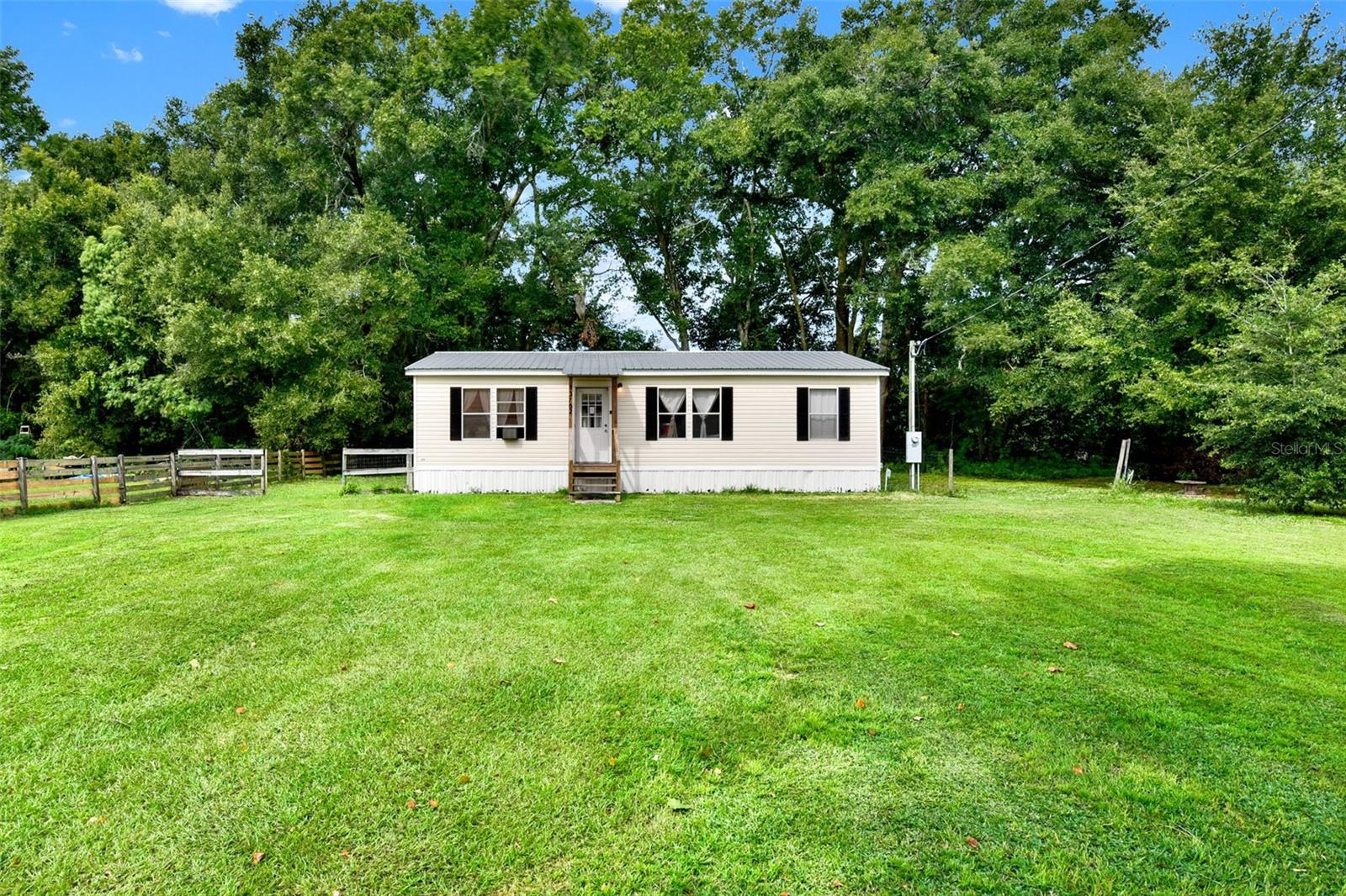 Conveniently located just off of Highway 484 between US HWY 301 and I-75, you will find this 3BR/2BA gem ready to call "Home". Built in 2008, no HOA. this double wide manufactured home has been updated with a newer metal roof and covered entry, new laminated floors and new central AC, heap pump Unit. With +/- .36 Acres of luscious greens, wooded area behind, and a beautiful sycamore tree in the front lawn, you will have plenty of room to unwind in the natural surroundings. Not only does it great curb appeal, but it features over 1,000 sqft of living space, a split floor plan with spacious living room, dinette, and interior washer/dryer hookups. Don't let this home slip by! Contact us today for your private showing. Price to sell fast.