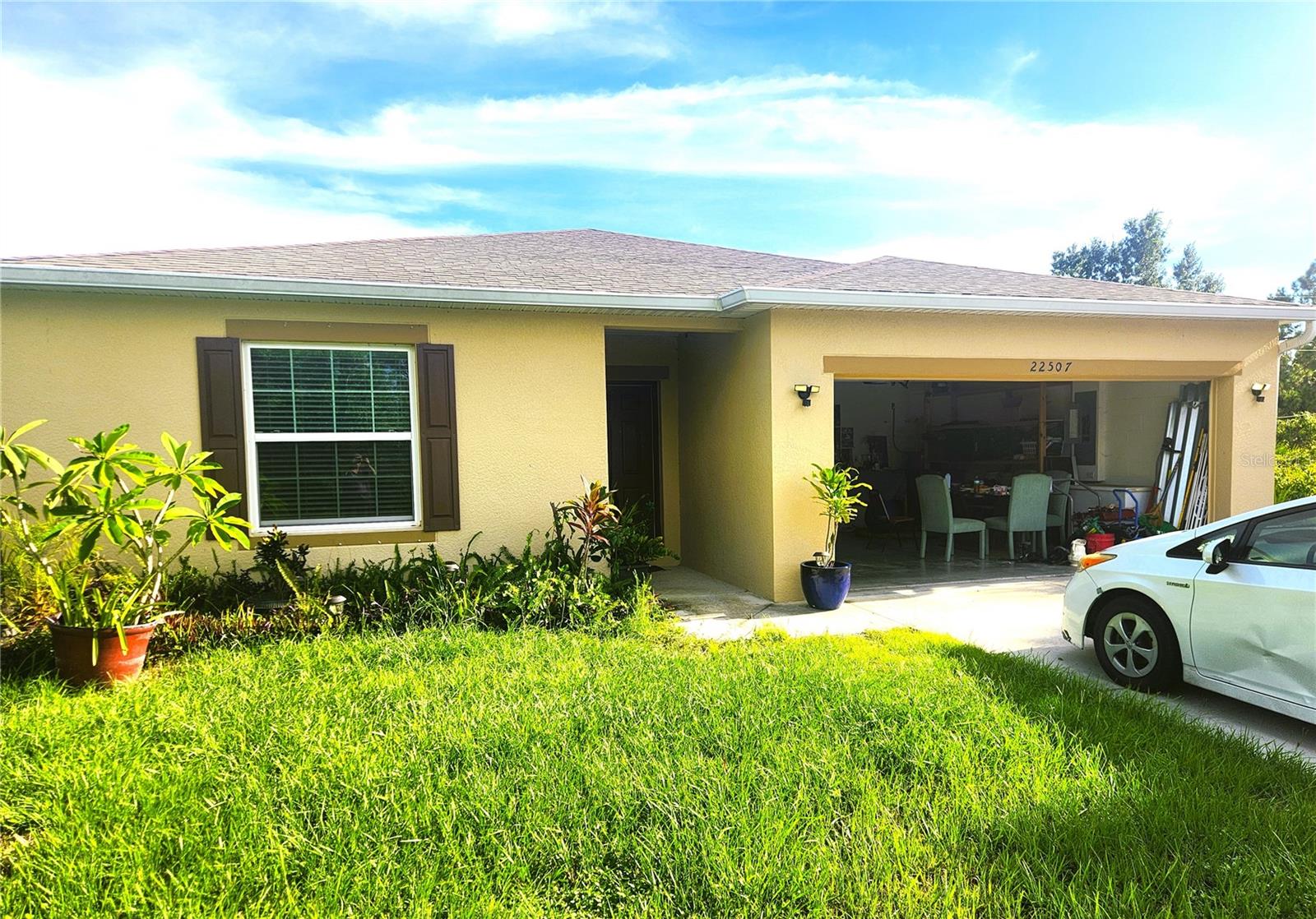This modern four-bedroom, two-bathroom home offers a comfortable and open living space. The floorplan seamlessly connects the living, dining, and kitchen areas, creating a spacious and airy feel. The home features ceramic tile throughout, a well-equipped kitchen with stainless steel appliances and a convenient pantry closet. A key feature of this home is the enclosed lanai, which has been converted into the fourth bedroom and bonus room, adding an extra 350 square feet of living space. This bonus space provides flexibility and an additional private room for a growing family, guests, or a home office.