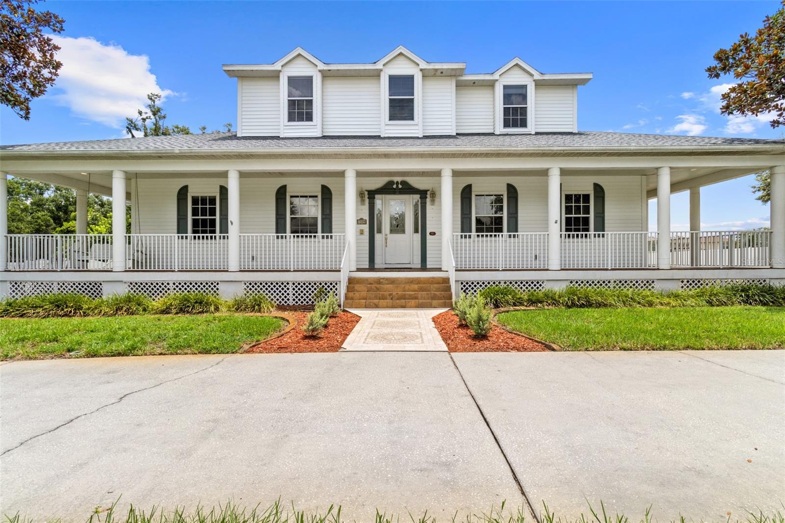 RARE FIND! 1.50 acres in sought after Lutz. Home backs up to conservation, offering no rear neighbors and extra privacy in your vinyl fenced yard. 2002 built home with a brand new roof (2025) with a transferrable warranty! One owner. Primary bedroom on the first floor with a coffered ceiling, 2 large walk in closets, private fireplace, dual sinks and access to your outdoor kitchen and screened in pool area. Downstairs you will also find a large eat in kitchen with an expansive butlers pantry. There is also a formal dining area, office, large interior laundry room and a versatile front room on your first floor. The opportunities are endless with an oversized garage and a 3rd garage on the back wing, and includes a full size bathroom. LOTS of storage, extra square footage and enough driveway to host all of your family gatherings. A winding staircase brings you to the upper level with an expansive loft, more storage, 2 oversized bedrooms and a great sized Jack & Jill bathroom - ideal for guests or family living. The home includes a central vacuum system, irrigation, No flood zone, No CDD.