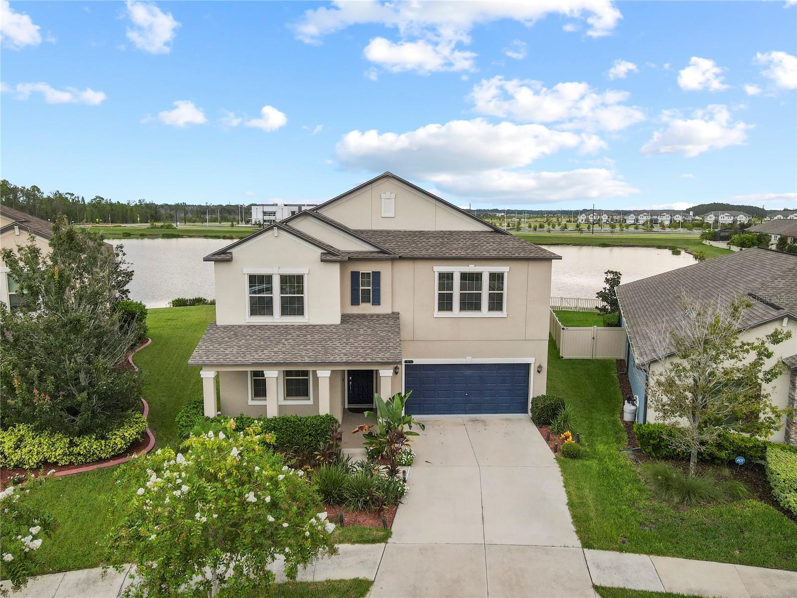 Stunning 5Bed/3.5Bath home with 3-car tandem garage in the award-winning community of Connerton! This 3,777 sq ft home offers an open-concept layout with a chef’s kitchen featuring granite countertops, stainless steel appliances with a GAS range, oversized island, and a HUGE walk-in pantry. The downstairs master suite includes dual walk-in closets, double vanities, soaking tub, and walk-in shower. Enjoy flexibility with a downstairs flex room and laundry rooms on both levels. Upstairs boasts a massive loft perfect for entertaining, 4 spacious bedrooms, and 2 full baths that both have double vanities. Relax in the screened lanai with outdoor kitchen, beautifully landscaped yard, and serene pond views—NO rear neighbors! Built in 2020 and move-in ready. Connerton offers resort-style amenities including pool, splash park, gym, trails, and more. Conveniently located near top schools, shopping, dining, and major highways. Don't miss your chance to make this your dream home!