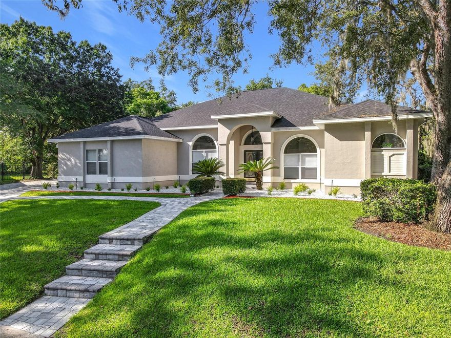 MAJOR PRICE REDUCTION - EXCEPTIONAL OPPORTUNITY! Welcome to a masterpiece of modern design and refined living in the prestigious Glen Eagle community of Tuscawilla. Built in 2023, this architectural re-imagining tucked away in a quiet cul-de-sac features 5-bedrooms and 3.5-baths and epitomizes luxury, sophistication, and thoughtful homage at every turn while encapsulating the modern family space. Bathed in natural light, the home showcases a brilliant interplay between design and illumination. Stunning porcelain tile with a marble-like finish flows seamlessly throughout the home, complementing the extravagant yet refined lighting fixtures that accentuate the home’s elevated aesthetic. The heart of the home is a show-stopping central kitchen, complete with sleek floor-to-ceiling white cabinetry accented with warm woodgrain niches and integrated LED lighting. A grand, white granite island offers an inviting centerpiece ideal for entertaining, culinary artistry, and family interconnectivity. The open-concept layout is enhanced by soaring ceilings and expansive windows, creating palatial living spaces that exude elegance and warmth. A substantial formal dining room is perfect for lavish dinner parties, while the stylish formal living room provides a serene space for conversation. The inviting family room, anchored by a sleek electric fireplace, flows effortlessly into the kitchen and living area—all overlooking the resort-style pool deck. The primary suite is a private sanctuary—expansive and serene, featuring a sun-kissed sitting area and direct pool access via a sliding glass door. The spa-inspired en suite bath is a statement in luxury, boasting a floating dual vanity with LED smart mirrors, an oversized walk-in shower, a single-piece designer toilet, and a custom walk-in closet designed for the discerning homeowner. Every secondary bedroom offers generous proportions and comfort, while the home’s layout has been meticulously planned for both privacy and flow. Step outside to a covered pool oasis with a pavered deck designed for year-round enjoyment. Whether hosting guests or relaxing in solitude, this outdoor haven is the perfect complement to the modern interior. Glen Eagle lies in the heart of the Tuscawilla community which features miles of walking trails, golf cart friendly roads, multiple parks and greenspaces including tennis and pickleball courts, as well as the Tuscawilla Country Club. A rare opportunity to own a truly bespoke residence in one of Central Florida’s most sought-after communities.
