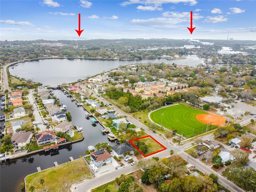 Prime Waterfront Lot with Private Dock – Build Your Dream Coastal Retreat in Tarpon Springs.

Imagine your dream home on this stunning, nearly quarter-acre waterfront corner lot, perfectly positioned along a deep-water canal with direct access to the serene Whitcomb Bayou. Just a 10-minute boat ride transports you to the open waters of the Gulf of Mexico, where the pristine beauty of Caladesi, Anclote, and the famous Three Rooker Islands await, offering sun-soaked shores and endless Gulf breezes.

This rare opportunity is more than just a piece of land—it's the foundation for your custom waterfront paradise. With no HOA, no CDD, and no deed restrictions, you have complete freedom to build a home that suits your lifestyle. Whether you're envisioning a sleek modern design or a charming coastal cottage, this lot provides the flexibility to bring your dream vision to life, exactly the way you want it. With ample space for a pool and lush outdoor entertaining areas, the possibilities for this parcel are as endless as the horizon. Bring your boat, your golf cart, and fully embrace the Salt Life, with direct access to the Gulf from your own private dock.

The property includes a survey and completed architectural designs for a stunning 4,200+ sq. ft. custom home, featuring a pool and optional elevator. Ready to build? Custom builders and new construction lenders are available, offering financing options as low as 5% down with no payments until the home is completed.

Beyond the lot, this prime location places you in the heart of historic Tarpon Springs, a charming town known for its rich Greek heritage, vibrant Sponge Docks, and delicious seafood. Beautiful beaches like Fred Howard and Sunset Beach are less than 10 minutes away, offering the perfect backdrop for both adventure and tranquility.

This is your chance to create a dream home in a true boater's paradise. Seize the opportunity to build your custom coastal oasis and enjoy the best of Florida’s Gulf Coast lifestyle. Contact us today to explore this exceptional property and begin planning your new waterfront retreat!
