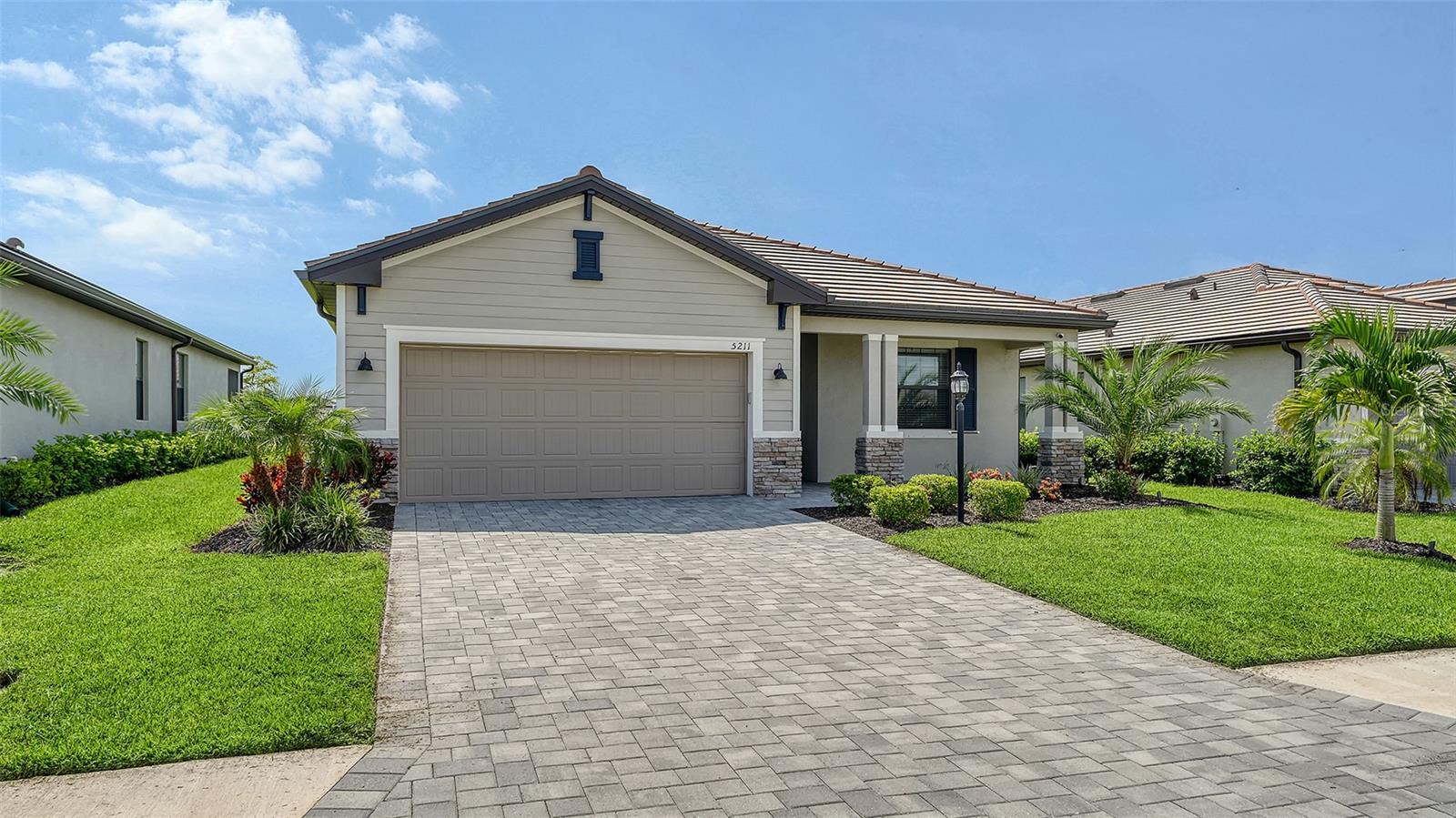Discover the epitome of Resort-Style Luxury at 5211 Marina Basin Court, an exquisitely upgraded 3-bedroom, 3-bathroom home in the amazing Resort-Style of Lorraine Lakes at Lakewood Ranch. Crafted in 2023, this contemporary single-family haven boasts 1,840 square feet of refined living space, complete with a tranquil Water View and a suite of Premium Enhancements that set it apart from standard models.
Step inside to discover a bright, open floor plan with tile flooring throughout, custom paint finishes, and crown molding adding a touch of sophistication. The gourmet kitchen is a chef's dream, featuring top-of-the-line appliances including a Frigidaire counter-depth refrigerator-freezer, KitchenAid top-end dishwasher with a third rack, KitchenAid gas range, and KitchenAid convection microwave. Both master bedroom closets boast custom designs for optimal organization, while high-end Hunter ceiling fans with Bluetooth connectivity and remotes ensure comfort in every room.
Smart home integration includes Google Nest features like outside cameras, a smart door lock, and doorbell for enhanced security and convenience. Additional interior upgrades encompass vertical blinds on the interior slider and a custom roller shade on the front door. Outside, professional landscape lighting illuminates the property, gutters surround the entire house for practical maintenance, and ceiling garage storage maximizes utility space.
Lorraine Lakes is a resort-style gated community with 24-hour guard service and an impressive lineup of amenities designed for an active, luxurious lifestyle. Enjoy the poolside bar & grill, splash pad, game room, state-of-the-art fitness center, tennis courts, pickleball, sand volleyball, indoor basketball court, and much more—all just steps from your door.
Priced to moved, this gem combines modern upgrades, low-maintenance living, and unparalleled community perks. Don't miss your chance to call this Lakewood Ranch paradise home—schedule a showing today!
