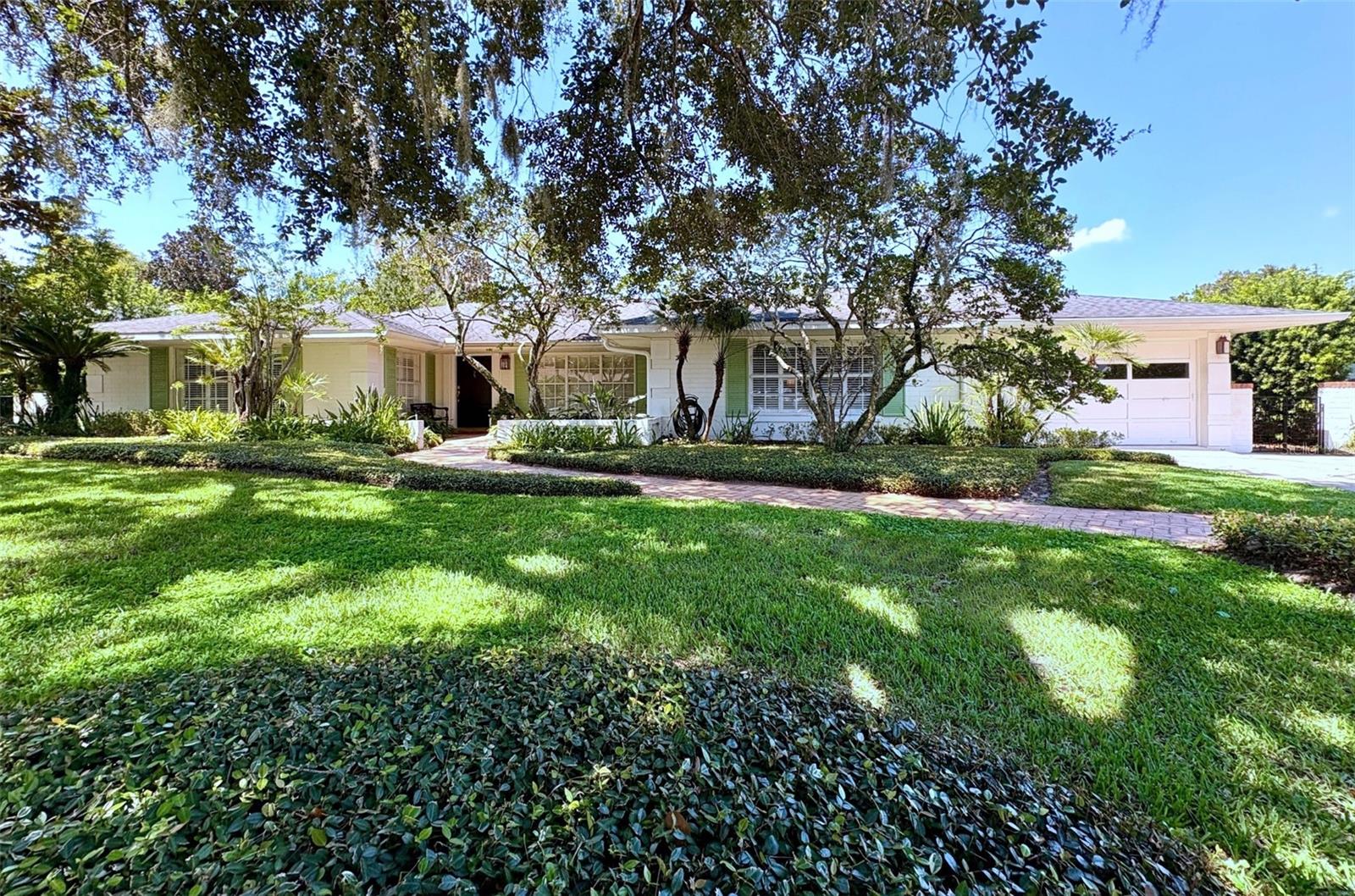 Under contract-accepting backup offers. Situated in the heart of Park Grove, one of Winter Park’s most coveted neighborhoods known for its oversized lots and graceful single-story homes, this residence offers more than 3,500 square feet of beautifully updated living.
The thoughtfully remodeled kitchen (2023) features Bosch and KitchenAid appliances, double oven, a warming drawer, and a limestone fireplace, seamlessly blending modern convenience with timeless design. The primary suite is a private retreat with a Carrera marble outfitted bath; showcasing dual vanities, a jetted tub, and an oversized shower with bench. Guest baths have been updated in the same timeless style.
Recent improvements include full house replumbing (2023), refinished hardwood floors (2024), HVAC (2022), and roof (2017).
Set on a .34-acre lot, the home’s backyard is designed for both relaxation and entertaining with an oversized lap pool, baby pool/swim out, salt/chlorine generator, dry cedar sauna, outdoor shower, and lush landscaping that includes a mature (and blooming!) avocado tree.
This is a rare opportunity to own a move-in ready home in Park Grove, offering a blend of elegance, thoughtful updates, and resort-style outdoor living in one of Winter Park’s most distinguished settings.
