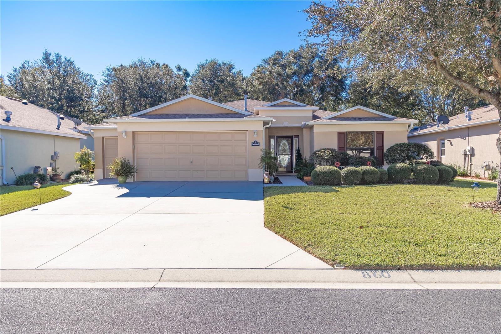 Step into this stunning 3-bedroom, 2-bathroom home with a 2-car garage plus a convenient golf cart garage, perfect for those who enjoy the Florida lifestyle. Recently updated with a new HVAC and water heater (2024) and fresh paint and waterproof wood laminate flooring (2022), this home feels like new! From the moment you approach the beautiful etched glass front door, you’ll be captivated by the inviting details. The wide-open foyer leads to a spacious, open-concept living and dining area, providing plenty of room for your favorite furniture and entertaining. The cozy kitchen boasts real wood cabinetry with crown molding, sleek hardware, and Corian countertops with a breakfast bar, ideal for casual dining or morning coffee. The dining nook is large enough to double as a formal dining space, offering flexibility for gatherings. Retreat to the expansive master suite featuring a walk-in closet, dual vanities, and a walk-in shower. Thoughtful touches like detailing on baseboards add a touch of elegance throughout. The extended epoxy coated garage accommodates larger vehicles like a truck, and the private screened lanai overlooks a fenced rear lot, offering serene outdoor living just steps from the back gate. New poured concrete patio provides space for lounge area or outdoor grilling area. Located in the vibrant 55+ community of Summerglen, you’ll enjoy a wide range of indoor and outdoor amenities, including golf and a delicious on-site restaurant with a menu to please any palate. Plus, the low HOA fee of $375/month includes mowing and edging of the yard, trash, Wi-Fi, and cable—making life here even more convenient! Don’t miss the chance to call this beautifully updated home your own. Schedule your private showing today!
