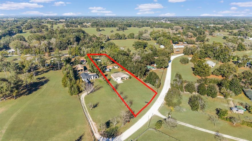 Two Homes on 1.44 Acres | Zoned A1 | No Restrictions
Welcome to a truly unique opportunity—this beautifully maintained 1.44-acre property features two separate residences, offering the perfect setup for multi-generational living, rental income, or guest accommodations. Located just 10 minutes from I-75 and 20 minutes to Ocala, this mini-estate is fully fenced, zoned A1 for your animals, and has no deed restrictions.
The main residence, built in 2015 by Triple Crown Homes, offers 2,482 square feet of thoughtfully designed living space. Step inside through an impressive 8-foot front door and enjoy the open layout with 9"4-foot ceilings throughout. The split-bedroom floor plan includes four spacious bedrooms and two full bathrooms, plus numerous upscale touches like rounded wall corners, granite countertops, stainless steel appliances, and ceiling fans in every room. A large enclosed lanai provides a peaceful indoor-outdoor retreat, ideal for entertaining or relaxing in the Florida breeze. The primary suite is generously sized and includes dual walk-in closets, a walk-in shower, and a soaking tub for a spa-like feel. Additional perks include a two-car garage with screen sliders, a generator hookup, and a water softener system.
Tucked away behind the main home is the second residence, a charming 2-bedroom, 2-bathroom concrete block home with over , 300 square feet of just living space and its own two-car garage. Recent updates include a brand-new roof, and the home offers a comfortable layout, vinyl-enclosed back porch, and an adjoining screened outdoor patio perfect for relaxing or entertaining guests. This second home is ideal for extended family or rental possibilities.
The property also includes a storage shed, lush open space with mature trees, and room for livestock, pets, or hobby farming. Whether you're seeking space, flexibility, or rental income potential, this property is a rare find that checks all the boxes.
Conveniently located just 10 minutes to I-75, 20 minutes to Ocala, and within easy reach of Gainesville, and just 5 minutes to nearby shopping and dining.