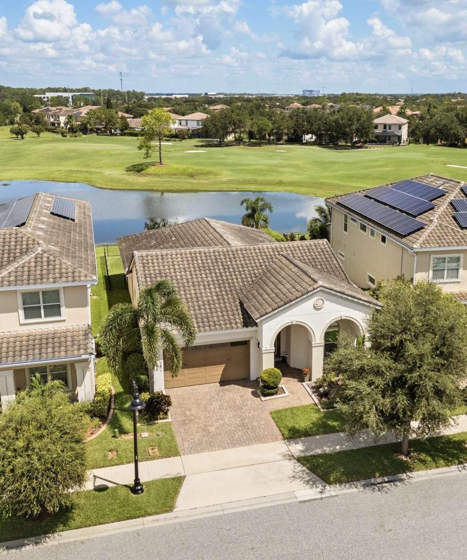 Discover peace and tranquility in this stunning, premium lot home offering both golf and water views in the highly sought after, 24 hour Guard-Gated, amenity-rich Golf Course Community of Eagle Creek. This Stunning four-bedroom, three-bathroom residence boasts an open-concept living area with soaring ten-foot ceilings, creating a spacious and airy feel throughout. The gourmet kitchen is a chef's delight featuring an oversized island perfect for gatherings, a walk-in pantry for ample storage, and sleek and modern finishes. Charming white brick accents add warmth and character to the home, elegantly showcased behind the stylish coffee bar and as a striking focal point in the living room, blending modern sophistication with timeless appeal. Elegant crown molding adorns the living areas and master bedroom. The spacious living area features stacked sliding glass doors that seamlessly open to a beautifully designed, enclosed paved lanai, perfect for indoor-outdoor living and entertainment. Here you can soak in breathtaking sunset views over the golf course and serene water vistas. The expansive master suite is a true retreat, featuring a luxurious walk-in shower, a freestanding tub, and a massive walk-in closet. Nestled just minutes from Medical City, Orlando International Airport, and world-renowned theme parks, this home is surrounded by top-rated schools and a vibrant community boasting exceptional amenities, including tennis and basketball courts, a community center, a fitness gym, three sparkling pools, and a fun-filled splash pad. No CDD! Schedule your private showing today!