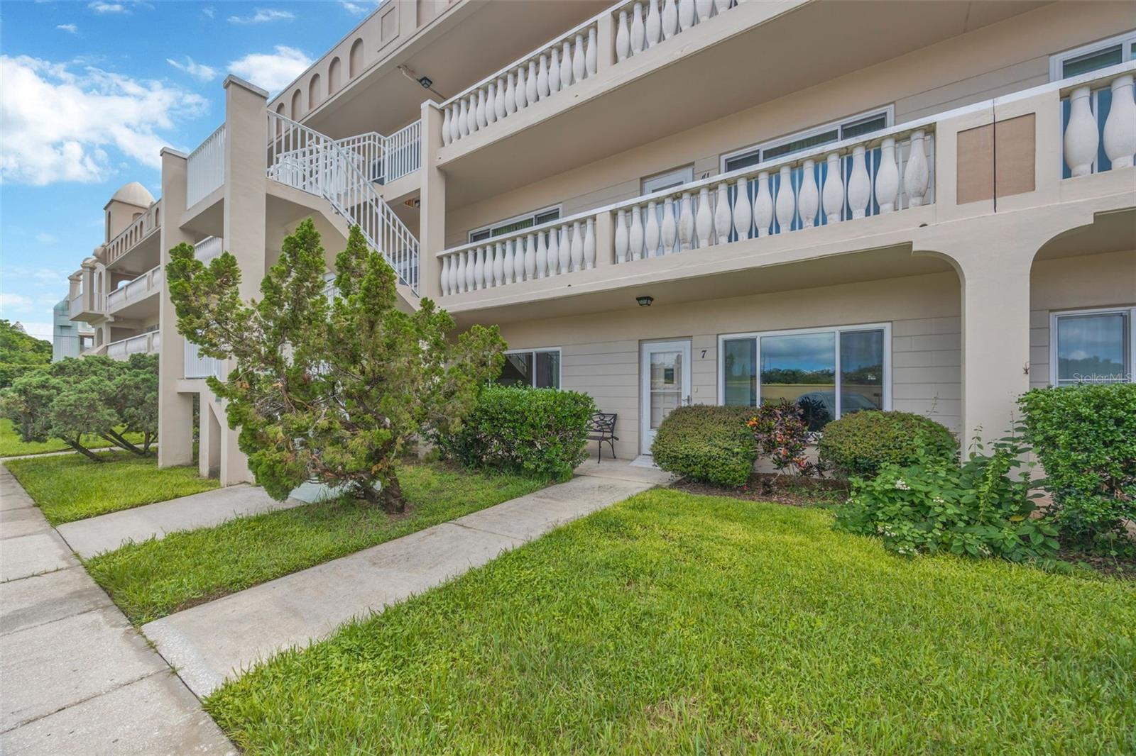 LOOK NO FURTHER! Rarely available first-floor unit with a covered rear patio in the highly desirable, amenity-rich On Top of the World community! This spacious 2-bedroom, 2-bath condo offers 1,340 sq. ft. of comfortable living space, freshly painted and move-in ready. The flexible floor plan allows you to tailor the space to your lifestyle, while the kitchen’s charming wood beam ceilings create a warm, inviting ambiance. The primary suite features an en-suite bath, generous closet space, and abundant storage. Additional highlights include in-unit washer/dryer, impact windows throughout, a new HVAC, and a newer hot water heater. Step outside to your private covered patio, perfect for morning coffee, grilling, or simply enjoying the Florida lifestyle. Can be sold furnished or unfurnished - it's up to you! Residents of On Top of the World enjoy resort-style amenities, including two private golf courses, multiple pools, fitness centers, tennis and pickleball courts, walking trails, lakes, a dog park, and an endless calendar of clubs and activities. Community transit and nearby shopping make daily life easy and convenient. This vibrant 55+ gated community truly lives up to its name!