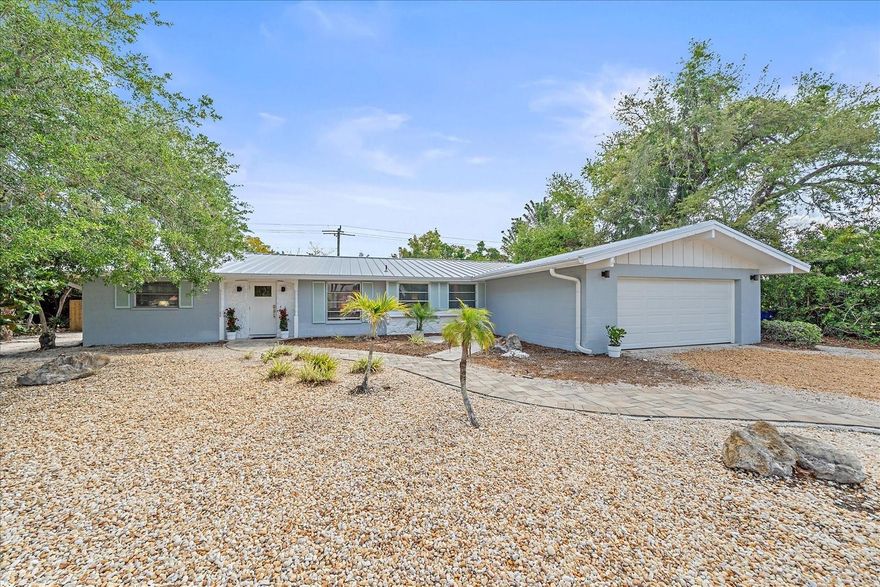 Island living meets easy everyday comfort in this turnkey furnished Siesta Key pool home. With 3 bedrooms, 2 bathrooms, approximately 2,168 square feet of living space and a 2-car garage, there is room for full-time living, a vacation getaway, or a high-demand rental.
Built of concrete block, this Ruth Richmond home offers peace of mind with major updates already done: brand new metal roof with warranty (April 2026), AC with warranty (August 2023), garage door (March 2025), front door (April 2025), and low-maintenance terrazzo flooring. Step inside to an inviting, well-planned layout with the primary suite on one side of the home with updated ensuite bath, and guest bedrooms on the other, offering privacy for family and visitors. The newly updated kitchen features granite countertops and modern finishes. The living room, dining area, and sunroom flow together seamlessly and overlook your private backyard oasis. 
Outside, enjoy your own sparkling, “sports pool” with a shallow area across the center, ideal for hosting friends for a game of pool volleyball, playing with the kiddos, or lounging. A brand-new fence with self-closing gates (April 2025) wraps the yard in privacy, creating a quiet retreat after a day at the beach.
Located on world-famous Siesta Key with low HOA fees of just $500 per year, you’re just minutes from the white quartz sand beaches, charming village shops and restaurants, boating, kayaking, and all the island lifestyle has to offer. This home combines an incredible coastal location with everyday convenience.
Turn the key, drop your bags, and start living the Siesta Key lifestyle at 611 Venice Lane.