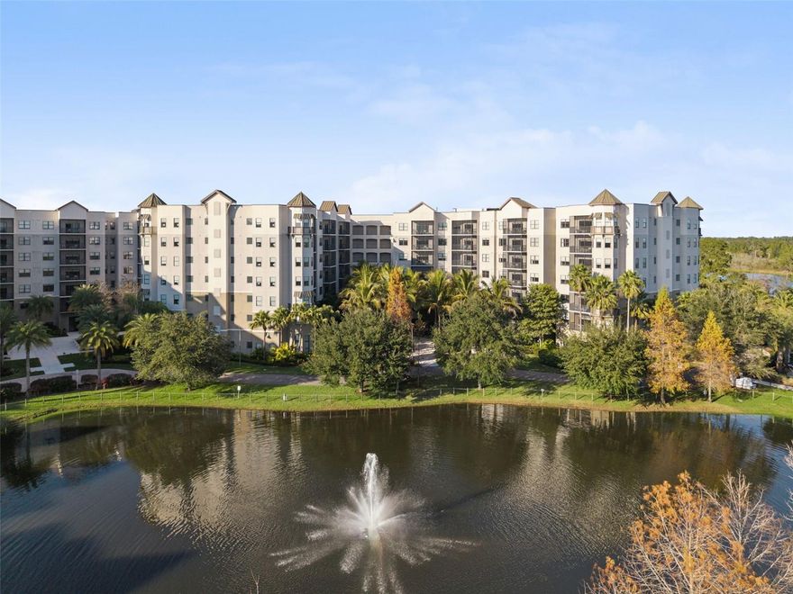 Ground Floor Unit | Pond and Fountain Views | Aggressively Priced Ground floor residence featuring 14 foot ceilings exclusive to first floor units, creating an open and spacious main living area. Ideally positioned within the community, the unit offers quick access to nearby resort amenities. Ground level units are often favored for vacation use due to convenient access without stairs or elevators. The screened private lanai overlooks a courtyard with pond and fountain views, framed by lush landscaping and mature palm trees. Interior features include stainless steel appliances, granite countertops, and a full size washer and dryer. The well designed split floor plan includes two bedrooms plus a pull out sofa, accommodating up to six guests. The community is professionally managed as a Condo Hotel, offering owners participation in an on-site rental program to help offset ownership costs when the unit is not in use. HOA fees conveniently covers all utilities as well as pest control, sewer, trash, and common-area insurance. Located within The Grove Resort & Water Park, a Disney World® Good Neighbor Hotel, owners and guests enjoy Surfari Water Park, FlowRider® surf simulator, fitness center, on site dining, walking trails, covered parking, lake access, and shuttle service to the Walt Disney World® Resort.
________________________________________