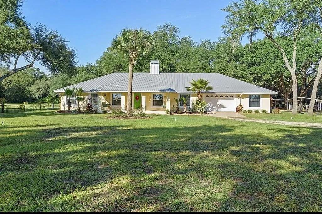 Love Country Living? Well, call to preview this fabulous 5+- acre mini-ranch fenced with a custom 3 bed 2 bath CBS home with over 2500 sq ft living area, split floor plan, great room with cathedral ceilings and fireplace, very nice kitchen with Corian counter and wood cabinets, spacious laundry room, 2 car garage with large office/studio and a large screened porch. Plus detached 2 car workshop, RV carport, and a couple of additional covered storage units. Bring your horse too! The property offers a small stall barn and tack room. All of this plus so much more. Conveniently located to Lake Wales shopping, area schools and recreation. Don't delay, call today for an appointment to see this property.