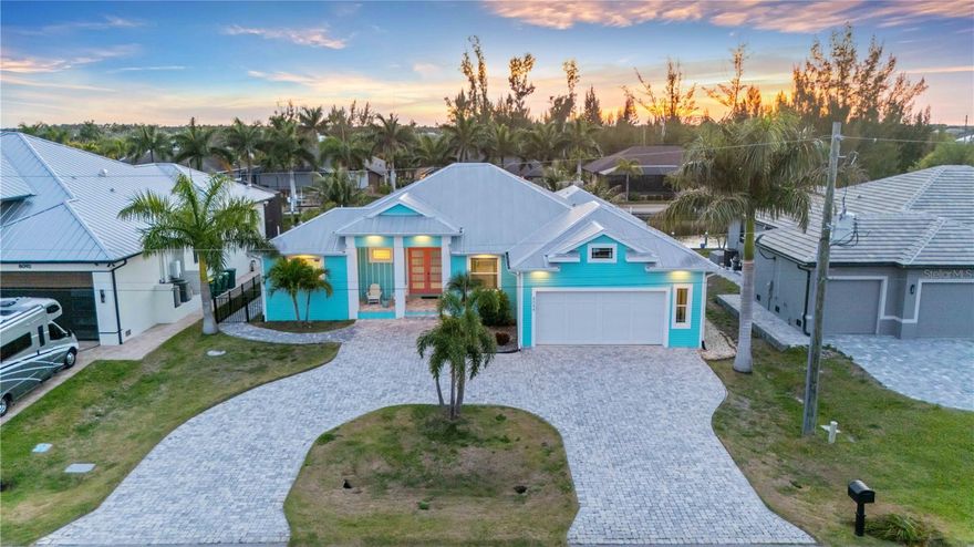 Welcome to your piece of paradise located in the highly sought after community of South Gulf Cove. This stunning Key West inspired home offers great water access with only one bridge to open water, a concrete seawall, and gorgeous sunset views from your pool. Some top destinations nearby include Boca Grande, Pine Island, Cayo Costa, Captiva, and Manasota Key! No need to bother with shutters, your new home is protected 24/7 with Hurricane Rated Impact Windows and Sliders. Upon arriving, you will notice the attractive appeal of the metal roof, paver circular driveway, and open front porch. Once inside, you will be captivated by custom features throughout such as coffer ceilings, diagonal tile, crown molding, upgraded fixtures, crown molding and more. The living and dining room overlook the lanai with a zero-corner slider giving you a great space to entertain guests. The kitchen features high end finishes, quartz countertops, built in wall oven, wine fridge, tile backsplash, and a smart fridge you can stream on. The primary bedroom is spacious with direct lanai access while the primary bathroom has his & her sinks and what is likely the most impressive shower you’ll come across.On the opposite side of the home there is a second en suite bedroom & bathroom setup that is perfect for guest privacy or could possibly be used as an in-law suite. Down the hall you will find a large 3rd bedroom and the guest bathroom which matches the rest of the home. There is also a large laundry room, pantry, and bonus room that could be used as a den or private office. The lanai offers plenty of deck area to relax both inside and outside your screened in area giving you the best of both worlds and of course the pool is heated for year-round enjoyment. This home already looks perfect, so it could also be optionally sold as furnished allowing you to move right in. Ask your agent for the fully interactive 3D tour and prepare to fall in love!