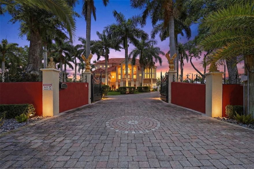 One or more photo(s) has been virtually staged. Welcome to a truly extraordinary estate where luxury, privacy, and endless possibilities come together in the heart of Tampa. Situated on five expansive acres with agricultural zoning, this one-of-a-kind property offers a rare combination of refined living and versatile land use—perfect for those seeking both elegance and opportunity. Spanning over 9,000 total square feet, with more than 6,200 square feet under air, this residence is designed to impress at every turn. From the moment you arrive, you’re greeted by a grand entrance framed by soaring windows exceeding 20 feet in height, filling the home with natural light and showcasing its breathtaking architectural design. Inside, timeless sophistication meets modern luxury. Original Versace tile flooring imported from Italy sets the tone for an elevated living experience, complemented by stunning chandeliers and dramatic high ceilings that create a sense of grandeur throughout. A sleek glass-railed staircase adds a contemporary touch, seamlessly blending classic and modern elements. The gourmet kitchen is nothing short of spectacular—fully updated and designed for both everyday living and entertaining at the highest level. Every detail has been thoughtfully curated to deliver style, functionality, and elegance. This estate also features a private home theater, offering the ultimate cinematic experience from the comfort of your own home. Step outside and discover your own private oasis. The recently remodeled pool invites you to relax and entertain in style, surrounded by lush landscaping and over 20 majestic royal palm trees. The grounds are adorned with a variety of fruit trees, including mango, guava, banana, plum, and avocado—creating a serene, tropical environment that feels like a private resort. With a tile roof, expansive outdoor space, and agricultural zoning, this property provides unique flexibility for a variety of uses while maintaining the highest level of luxury living. This is more than a home—this is a statement, a retreat, and an opportunity to own a truly exceptional piece of Tampa.