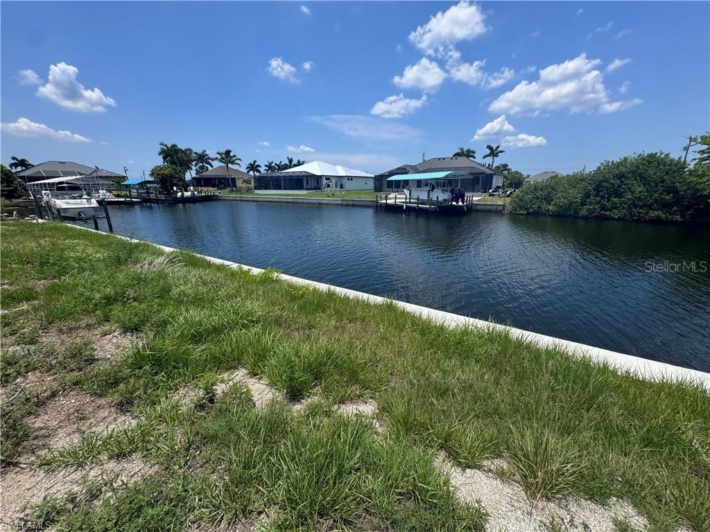 Nice and Cleared GULF ACCESS LOT with a NEW SEAWALL (10 Ft) in place. Located in the growing Northwest Section of Cape Coral Florida, this Lot is ready for that new construction home project. It is located on the Rococo Canal that is about 120ft wide with some INCREDIBLE views and fishing right from your backyard. Conveniently located less than 5 minutes to the Coral Oaks Golf Course, 15 minutes to Punta Gorda.
This location is part of the North 3 - 2025 City Water and Sewer Expansion which is now delayed until 2028. Just minutes from the North Spreader Canal, this location provides convenient access to Matlacha’s vibrant waterfront dining and charming island atmosphere. Additionally, it is located near the highly anticipated Seven Islands project, a future Cape Coral landmark featuring mixed-use spaces, upscale restaurants, marinas, and entertainment.
Enjoy breathtaking sunsets every evening with the lot’s desirable western exposure, providing a serene and picturesque backdrop for your future home. Imagine designing your ideal residence on this prime piece of real estate, where every day begins and ends with the tranquility of waterfront living. Whether you’re an avid boater or simply seeking a slice of paradise, this lot provides the perfect canvas for your vision.