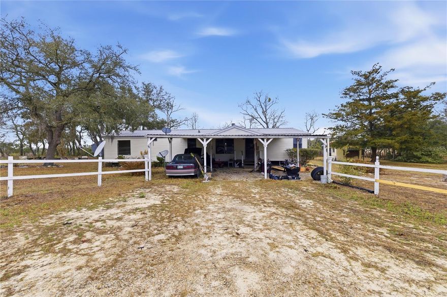 This peaceful 10-acre homestead is the private escape you’ve been searching for—tucked away where you can truly enjoy the quiet, with no nearby noise or neighbor distractions. The spacious 3-bedroom, 2-bath double-wide manufactured home offers a comfortable, inviting layout and is ready for you to make it your own, with most of the renovations already completed for you. Inside, you’ll love the warmth and character of the open fireplace positioned between the living room and bonus room—perfect for cozy nights in, relaxing, or entertaining. The eat-in kitchen provides a welcoming space for everyday meals, while the inside laundry room adds everyday convenience. Step out back to the large extended screened porch, an ideal spot to sip your morning coffee, enjoy meals outdoors, host friends and family, or simply take in the peaceful views—the possibilities are endless. Designed for a true farm lifestyle, the property is completely fenced and includes four individually fenced paddocks, along with a pig pen, bunny house, chicken coop, kennel, and multiple functional outbuildings including a fully functioning workshop, storage area, and a charming she-shed. A well-dug shooting range adds even more versatility to this unique property. With a metal roof, outstanding privacy, and plenty of room for animals, hobbies, and wide-open living, this is a rare opportunity to own a fully equipped rural retreat that’s ready to enjoy.