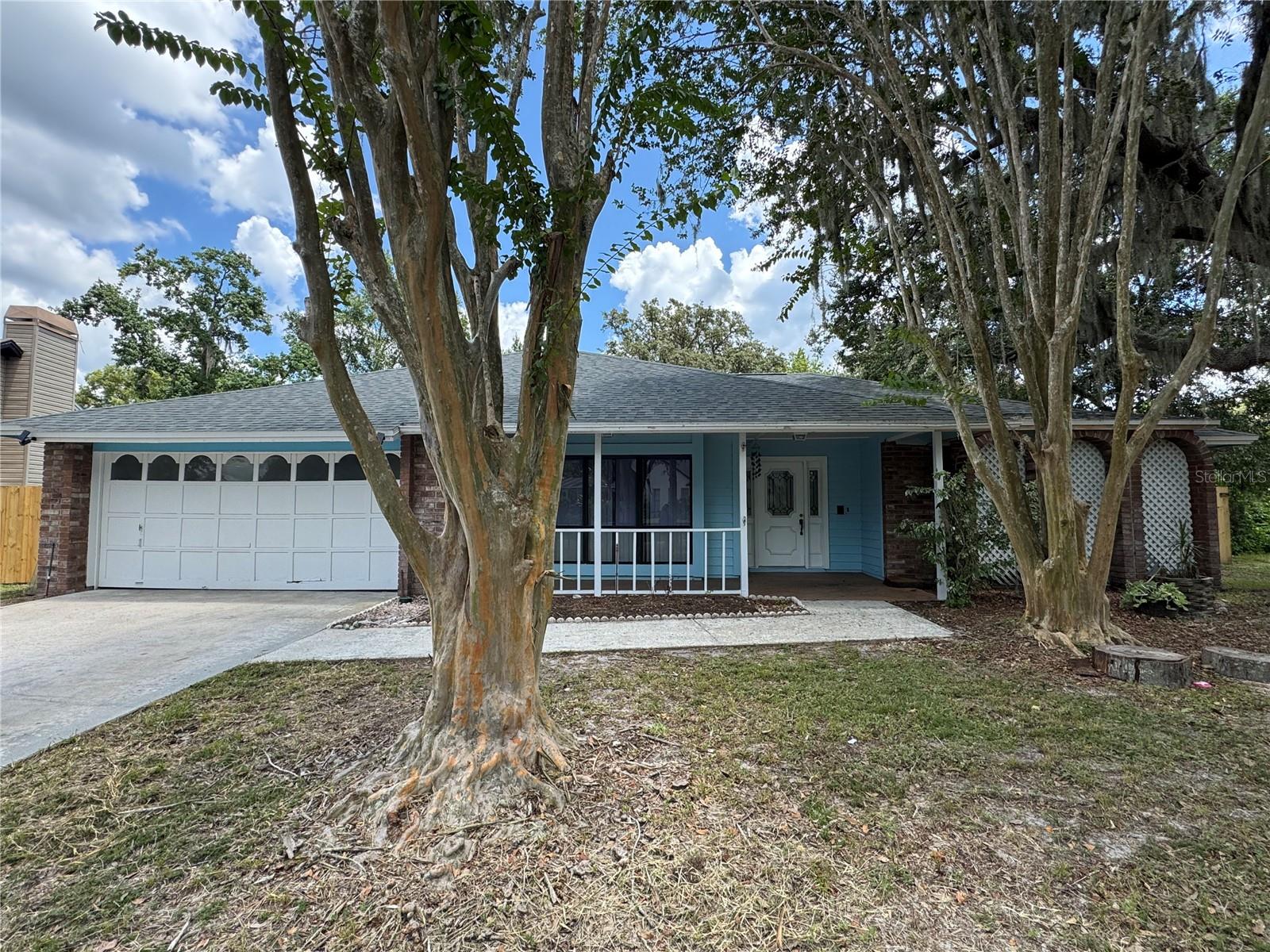 Welcome to this stunning 4-bedroom, 2-bathroom home featuring a sparkling screened pool and an oversized backyard perfect for outdoor entertaining. Step inside to a spacious layout that includes a formal living area, dining room, and a cozy living room with a fireplace, all visible from the large kitchen with an island—ideal for hosting and everyday living. Enjoy Florida living year-round with a covered front patio and a large covered back patio overlooking the pool. The master suite offers private sliding glass door access to the pool, along with a luxurious bathroom featuring a walk-in shower, garden tub, and dual vanities. The guest bathroom also includes dual sinks, a shower/tub combo, and convenient access to the pool. A generous laundry room adds extra functionality to this beautifully designed home. Located just minutes from top-rated schools, shopping, and a variety of restaurants, this home offers the perfect blend of comfort, style, and convenience.