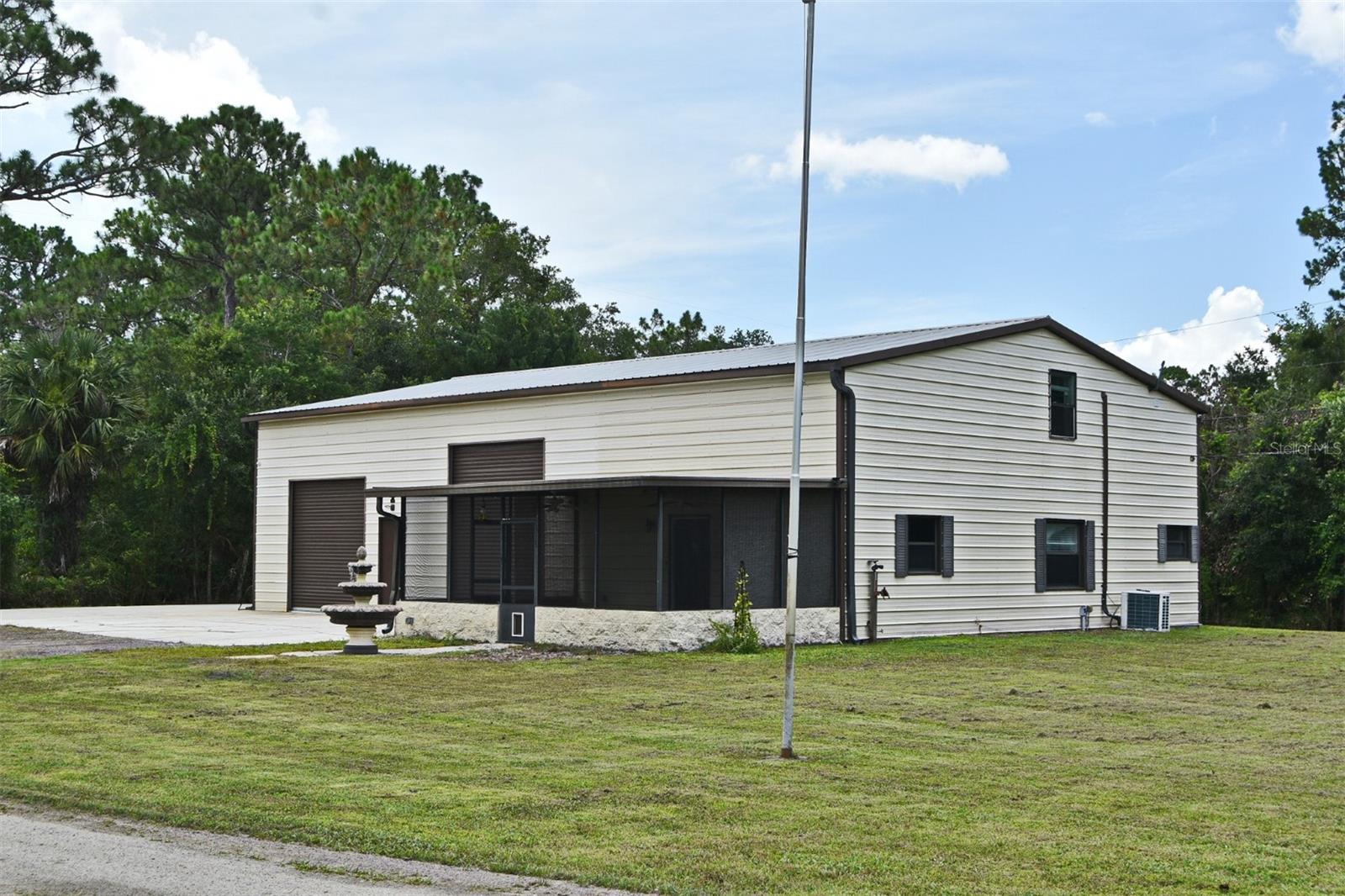 Located in the heart of Geneva this unique custom home is situated on over an acre of land and has a 2 bay garage large enough to hold over 6 cars, RV or boat. The floor plan features, one bedroom with 2 1/2 baths, a den, an eat-in kitchen with breakfast bar, family room with wood floors and an interior laundry room. The kitchen has stainless steel appliances with granite countertops and wood cabinets. The master bedroom and bath is located up with wood floors and has a private lofted walkway to the entry and also there is a a spiral staircase from inside the home to enter. Plenty of storage throughout including a 15x7 storage room upstairs off the master. The garage is 40x40 with 10ft and 12ft roll up medal doors, and a heavy duty 2 pole car lift. Also located in the garage is a half bath, a 13x10 workshop/storage room, a stainless steel mechanics work bench and a refrigerator. Enjoy the best of outdoor living & wildlife on your 21x14 screened front porch overlooking the huge yard with plenty of privacy and nature for all your entertaining and summer fun barbeques! No HOA and Top rated schools located in this Geneva community with close proximity to Lake Harney and convenitalety located to shopping, SR 417, Oviedo and Sanford with an abundance of restaurants and entertainment. Call today to see! This property may be under video/audio surveillance.