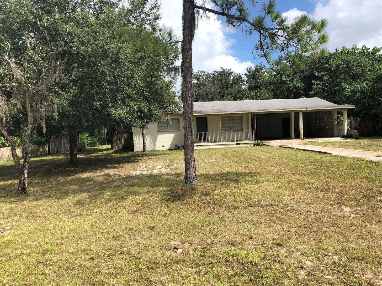 Enjoy the non subdivision atmosphere of this adorable 2 bedroom 1 bath home in N Lakeland. Exterior features include a large two car carport, front porch, fenced yard and storage shed. Inside there are two bedrooms, formal living room, eat in kitchen, large family room, indoor utility room with extra storage space. No carpet in home. Walnut wood floors in the living and bedrooms. Ceramic tile in the kitchen, family room and utility. Well and septic so no water bill. Available 8/5/2025. Sorry no pets.