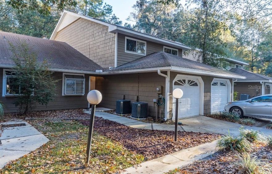 Charming townhome-style single-family attached home with private driveway, one-car garage, and full fee-simple ownership. This 3-bedroom, 2.5-bath, two-story home features a main-level primary suite with walk-in closet and peaceful forest views. Upstairs, two additional bedrooms offer space and comfort.

The kitchen opens to a spacious living and dining area with vaulted ceilings, two skylights, and abundant natural light. A cozy fireplace anchors the living area, perfect for relaxing.

Brand-new wood flooring upstairs, tile and wood throughout main living areas, Trane A/C units, and a new roof installed in 2021. The HOA covers roof replacement, master structure policy, and exterior maintenance for low-maintenance living.

Move-in ready with the perfect balance of modern comfort, convenience, and a serene setting.