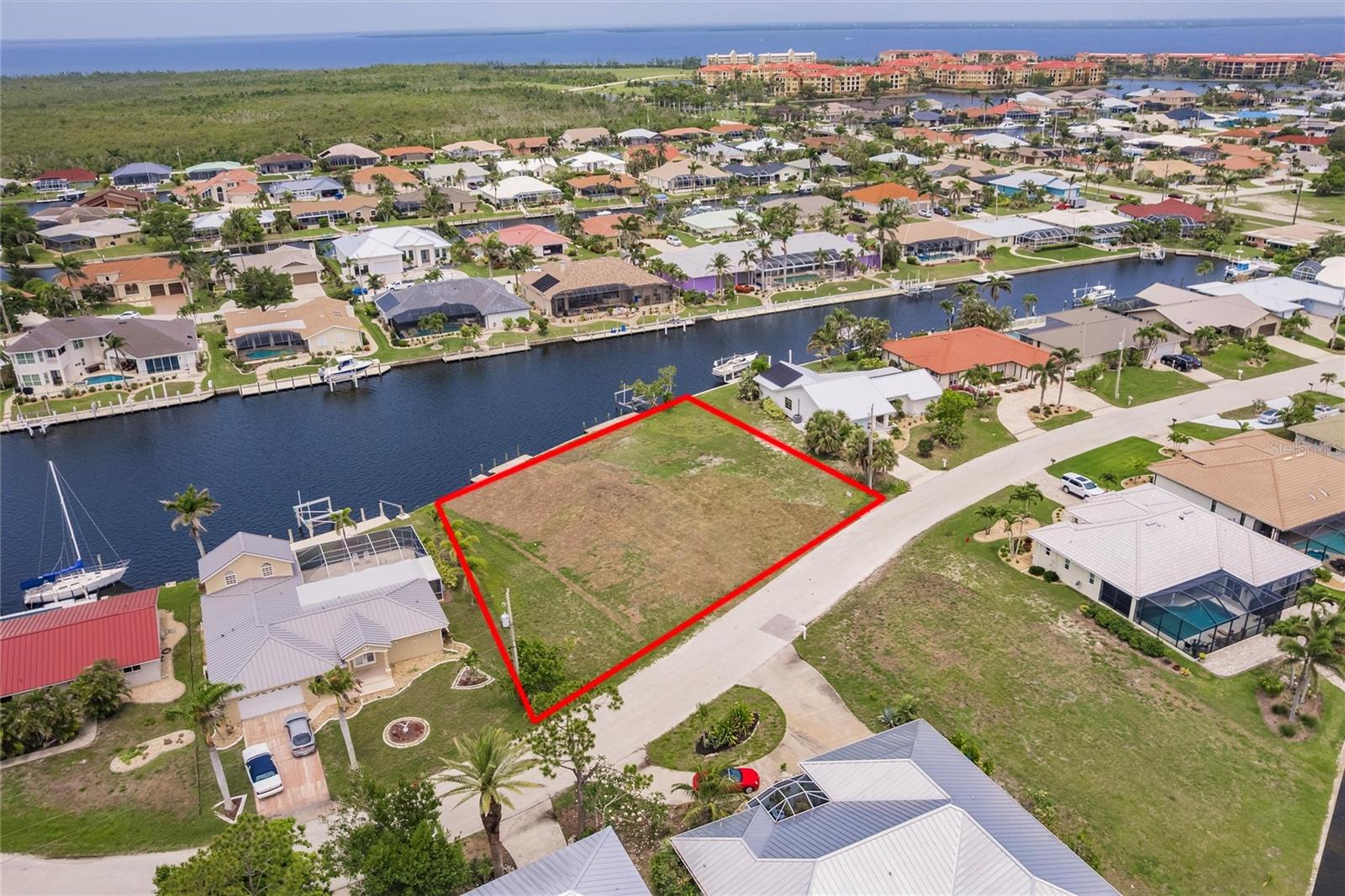 DOUBLE LOT! Build your dream home on this beautiful sailboat waterfront residential building lot in the waterfront community of Punta Gorda Isles. You are only minutes to the open waters of Charlotte Harbor and then on to the Gulf of Mexico. This oversized lot of almost half acre with 152 feet of water frontage will allow you to create your own tropical paradise. Public water and sewer available and concrete seawall in place. As an added bonus the seawall is maintained by the City of Punta Gorda. You will be able to fish and boat from your own back yard. And you will spend many hours enjoying the Florida wildlife, fish, and waterfowl that abound in this area. Proximity to local beaches, dining, shopping, and golf courses makes this property ideal for the Florida lifestyle. Also, easy access to public parks with bike and walking trails and picnic areas, and boat ramps providing access to many waterways, the Peace and Myakka Rivers, beautiful Charlotte Harbor, and the blue waters of the Gulf of Mexico.
And you are minutes to historic downtown Punta Gorda and popular Fishermen’s Village with quaint shops and cafes. This is a rare find. So grab your piece of Florida paradise today!