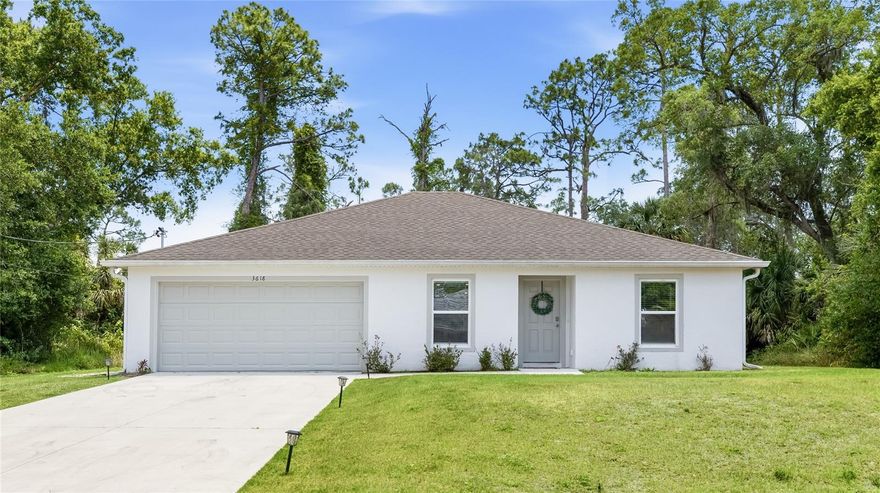 Welcome to this beautifully maintained 2022-built home nestled on a private lot with no HOA! From the moment you arrive, the clean white stucco exterior, manicured lawn, and landscape-lit driveway set the tone for what awaits inside. The open, flowing layout is filled with natural light and features luxury vinyl plank flooring throughout every room. The heart of the home is a well-appointed kitchen boasting white shaker cabinetry, stainless steel appliances, recessed lighting, and a breakfast bar peninsula perfect for casual dining. The kitchen flows seamlessly into the dining area and connects to the spacious living room, where sliding glass doors open directly to the backyard, bringing the outdoors in and making entertaining a breeze. The versatile sitting room off the foyer offers the perfect flex space for a home office, playroom, or reading nook. The primary suite features a generous walk-in closet and a private en-suite bath. Two additional bedrooms are well-sized with ample closet space and share a full guest bath. A dedicated laundry room and an attached two-car garage round out this thoughtfully designed floor plan. Out back, enjoy a large, private yard framed by a lush natural tree line of Florida pines, palms, and oaks, offering the kind of seclusion that's hard to find. Being a 2022 build, all major systems including the roof, AC, and water heater are just a few years old, giving buyers peace of mind for years to come. **THIS PROPERTY QUALIFIES FOR A 1% LENDER INCENTIVE IF USING PREFERRED LENDER. INQUIRE FOR MORE DETAILS.**
