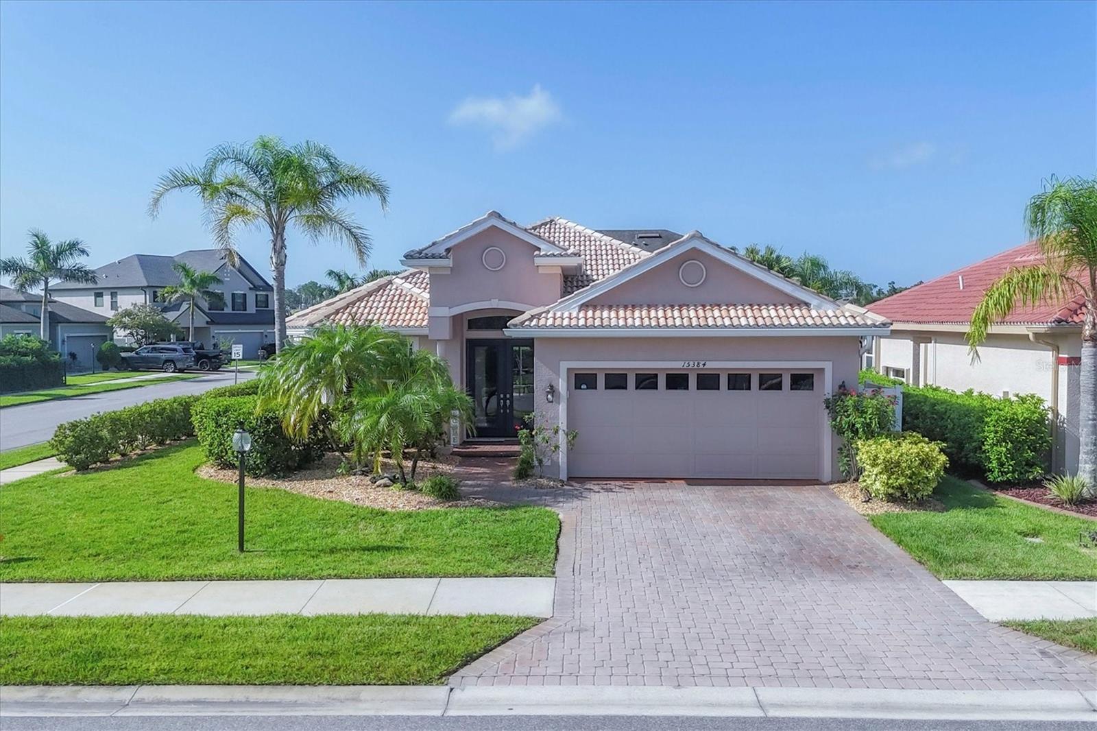Welcome to Villa Milano – A Peaceful Retreat in a Prime Location!
Tucked inside the charming gated, pet-friendly community of Villa Milano, this beautifully maintained custom-built home blends comfort, character, and thoughtful design. Situated on a desirable corner lot just steps from the community pool, it offers an ideal setting at the intersection of North Port, Port Charlotte, and El Jobean.
Built in 2007 with a host of quality upgrades, this light-filled home features a tile roof, paver driveway, and an inviting Great Room floor plan designed for easy living and entertaining. Throughout the home, you'll find stylish architectural touches such as decorative wall accents and elegant double tray ceilings, adding depth and charm to every room.
The spacious split-bedroom layout includes two bedrooms, two full baths, and a large den—perfect for a home office or guest overflow. The kitchen is a true showstopper, featuring 45-inch cabinetry, granite countertops, top-of-the-line appliances, and an oversized walk-in pantry.
The primary suite is a peaceful retreat with high double tray ceilings, three beautiful, oversized windows that bathe the space in natural light, and direct access to the lanai. The luxurious ensuite bath includes a large walk-in closet, dual vanities, a soaking tub, and a Roman-style walk-in shower for a spa-like experience at home.
Step outside to your private lanai, where you'll find a propane-heated, saltwater spa and a fully equipped outdoor kitchen with granite counters, a sink, and refrigerator. This expanded outdoor space is screened with a soaring cathedral cage, finished with elegant pavers, and surrounded by lush landscaping for added privacy.
Pet lovers will appreciate the fenced turf area—perfect for Fido to enjoy the Florida sunshine in comfort and luxury.
Additional highlights include a large interior laundry room, a two-car garage, public water and sewer, and access to a lovely community clubhouse and pool just a short stroll away. Unlike other homes in the community, this property is uniquely irrigated from the pond—meaning no additional watering expense for your landscaping.
Warm, bright, and beautifully cared for—this Villa Milano home is a true gem waiting to welcome you home.