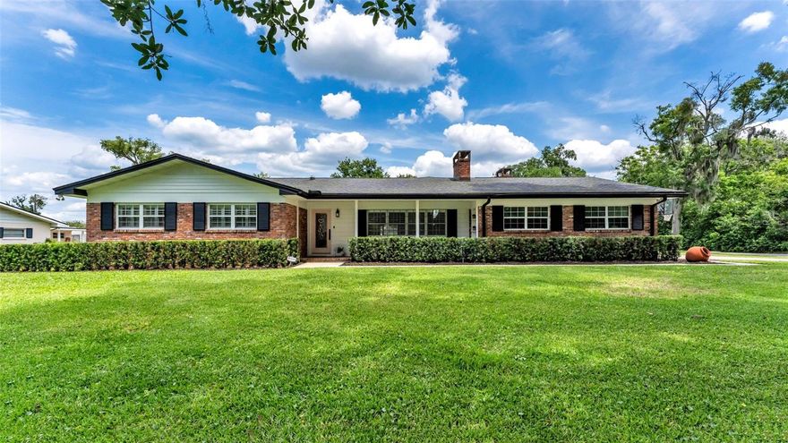 Located in the highly sought-after Hallam area of Lakeland, this beautifully updated property offers the perfect blend of space, character, and versatility on an oversized 0.59-acre corner lot. The main residence features 4 bedrooms, 2.5 bathrooms, and 2,640 square feet of living space with timeless finishes and a warm, inviting feel throughout. Real hardwood flooring flows throughout the main living areas and all bedrooms, adding warmth and timeless character to the home. The inviting front flex room features brick tile entry flooring, plantation-shuttered picture windows, built-in shelving, and a stunning brick wood-burning fireplace with accent details, creating the perfect setting for a formal sitting area, piano room, office, or additional flex space. The spacious living and dining combination offers crown molding, updated lighting fixtures, abundant natural light, and sliding doors leading to the home’s stunning screened lanai overlooking the backyard. The beautifully updated kitchen showcases granite countertops, tile flooring, custom cabinetry, and luxury Café appliances including a double oven, microwave, and dishwasher all approximately 3 years old. The primary bedroom suite features two built-in closets along with its own en-suite bathroom and walk-in shower. A spacious bedroom suite located adjacent to the main living area and kitchen includes a semi walk-in closet, fireplace detail, and attached half bath, making it ideal for guests, a private office, in-law setup, or flex living arrangement. The additional bedrooms and bathrooms provide comfortable accommodations for family and guests alike. The home also includes a two-car garage plus an additional office space or storage room, along with an oversized laundry room offering exceptional space for folding, storage, and organization. The living room overlooks the expansive backyard and impressive screened lanai featuring a stunning wooden vaulted ceiling. In addition to the spacious rear lanai, the home also offers a covered side open porch perfect for relaxing outdoors. A standout feature of the property is the recently updated 336-square-foot detached casita featuring a 1-bedroom studio-style space and 1 full bathroom with a tiled shower. Double French doors open into the casita, and a separate exterior access door provides additional privacy and flexibility for guests, multigenerational living, a private office, studio, gym, or income-producing opportunities. The oversized backyard offers endless possibilities with ample room to add a pool, outdoor entertaining areas, playground space, or gardens while still maintaining plenty of green space for recreation and relaxation. The roof is approximately 9 years old, water heater replaced just 3 months ago, washer and dryer approximately 1 year old, with the added benefits of a whole-house water filtration system, and a reverse osmosis system approximately 1 year old. Conveniently located just a short drive from Lake Hollingsworth, Lake Miriam Shopping Center, popular dining and shopping destinations, and several highly desired South Lakeland schools. Commuters will appreciate quick access to the Polk Parkway with easy travel to Tampa and Orlando, while nearby medical conveniences include the newly opened Watson Clinic and Orlando Health facilities. This rare Hallam property combines location, lot size, flexibility, character, and charm in one exceptional opportunity. Schedule your showing today.