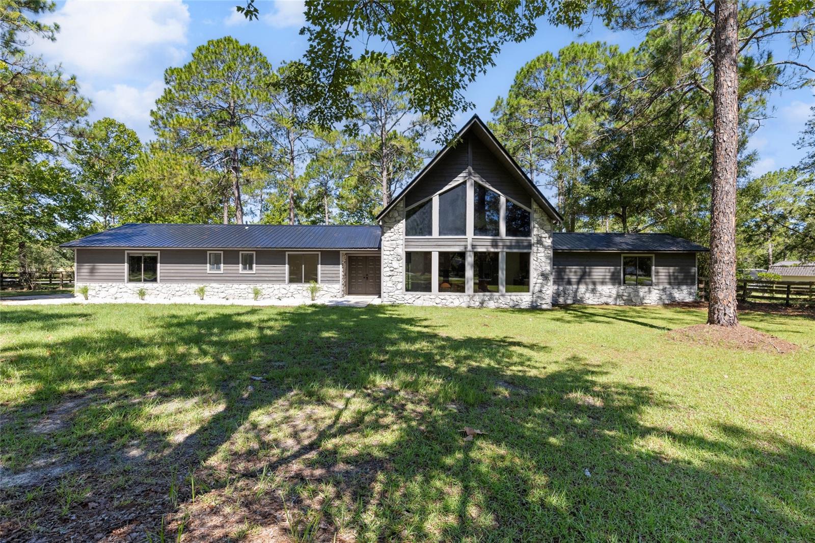 Welcome to this stunningly renovated 3-bedroom 2-bathroom home located in the desirable Meadows of Kanapaha community. Set on a spacious lot with mature landscaping, this home offers a perfect blend of modern updates and timeless charm. Step inside to find soaring cathedral ceilings and large windows that provide lots of natural light in the living spaces. The beautifully updated kitchen with real wood cabinets, quartz countertops, new stainless steel appliances flows perfectly with the living room that features a beautiful wood-burning fireplace and dry bar that is perfect for entertaining or everyday living.
The primary suite is a true retreat with high ceilings, a luxuriously redesigned bathroom boasting with a large walk-in shower complete with a rain shower head and a hand held faucet. This bathroom doesn't stop there as there is a double vanity and a make-up vanity. The primary suite is complete with dual closets and two sets of sliding back doors out of the bedroom and bathroom to access the back yard.
A standout feature of this home is the loft overlooking the main living area, complete with large picture windows that fill the space with sunlight- perfect for a home office, playroom, or reading nook. This home has a brand-new metal roof offering both style and long-term durability.
Additional highlights include:
-split floor plan for privacy
-brand new flooring and fixtures throughout
-indoor laundry
-spacious backyard with room to add a garden or play area
-No HOA, located in a well-established neighborhood
-New HVAC
Conveniently located near I-75, Celebration Pointe, UF, Shands, this move-in ready home combines comfort, style, and location.