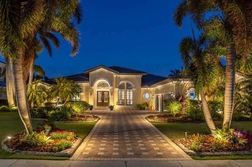 Experience the best of waterfront living, luxury, and community charm in the coastal enclave of MiraBay. This exquisite single-story retreat built by John Cannon showcases a thoughtfully crafted layout that harmonizes comfort, functionality, and breathtaking views. Upon entry, a gracious foyer leads into the expansive living room, where soaring ceilings and panoramic water views take center stage through large sliding glass doors. The open-concept design extends into the gourmet kitchen, featuring a center island, custom cabinetry, premium countertops, and a stylish backsplash. Adjacent to the kitchen, the dedicated dining room provides an ideal setting for hosting family and friends. A striking custom-built wine cellar serves as an impressive design feature and refined sophistication. With a 550-bottle capacity, this climate-controlled space is perfect for avid collectors and superior entertaining. The primary suite is a true sanctuary, offering breathtaking water views, sitting area, a spa-inspired en-suite bath, and 2 spacious walk-in closets. Generously sized secondary bedrooms are strategically positioned for privacy, each with access to well-appointed bathrooms. A separate office or flex space offers versatility—ideal for remote work or a private retreat. A dedicated laundry room provides ample storage and connects to a mudroom leading to the oversized garage. At the rear of the home, a versatile bonus room with direct lanai access and scenic water views offers potential as a media room, fitness area, or in-law suite utilizing adjacent bedroom/bathroom, enhancing multi-generational living options. Step outside to the covered lanai, where you can savor stunning sunset views over the water. The heated pool and spa feature LED lighting and a professional outdoor lighting setup, including pool cage nebula lighting, enhancing the ambiance and tranquility of outdoor living and entertaining. The fully equipped outdoor kitchen, with updated grill components, is perfect for dining and entertaining poolside. For boating enthusiasts, this home includes a 27,000-lb boat lift with a new motor (remote-enabled), updated aluminum bunks, a jet ski lift, and a recently renovated seawall. Meticulously maintained and masterfully updated, this home boasts a brand-new roof (2024), whole-home generator, two high-efficiency HVAC systems (2023), a tankless water heater, and a comprehensive Control 4 home audio system—ensuring modern comfort, efficiency, and an exceptional waterfront lifestyle. Nestled within MiraBay’s resort-style waterfront community, residents enjoy world-class amenities, including a clubhouse with a fitness center, a resort-style pool with a waterslide, tennis and basketball courts, scenic walking trails, and direct waterfront access for boating and kayaking. The community also features playgrounds, parks, on-site dining, and spa services—creating a perfect blend of recreation and convenience in a picturesque coastal setting. The allure of Apollo Beach includes a central location with easy access to Tampa, St Petersburg, Sarasota, beaches, shopping, dining, and recreation. Please view Virtual Tour for full Property Video and Floor Plan.