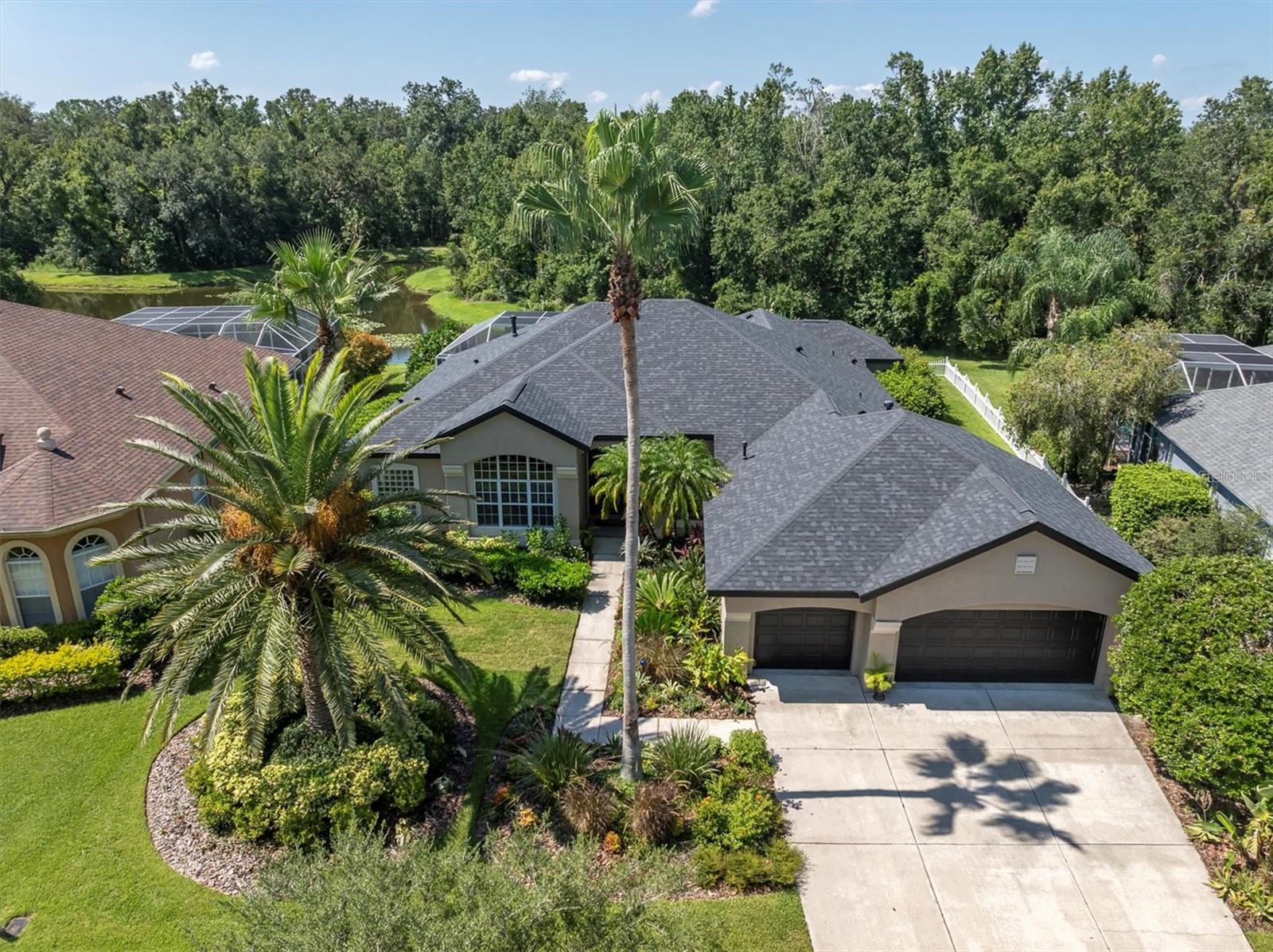 One or more photo(s) has been virtually staged. Welcome to this beautifully maintained single-story 4-bedroom, 3-bathroom home located in the exclusive gated enclave of The Laurels within the highly desirable Seven Oaks community. Built by Arthur Rutenberg, this residence sits on a rare ¼-acre lot offering incredible privacy, lush mature landscaping, and sweeping conservation views both front and back—plus a tranquil pond just beyond the screened lanai. With no front or rear neighbors, the setting is truly serene.
The outdoor living space is the crown jewel of this property. Step through large sliding glass doors to an expansive screened lanai featuring a sparkling pool and spa, a covered outdoor dining area, and a brand-new electric grill. Whether relaxing in solitude or entertaining guests, the natural beauty and peaceful ambiance make this space unforgettable.
Inside, the open split-bedroom floorplan is filled with natural light and designed for comfort. Highlights include high ceilings, a formal dining room, a dedicated study, and a spacious living room with a gas fireplace. The kitchen features a center island, stainless steel appliances, and a breakfast area that frames gorgeous backyard views. The owner’s suite offers private pool access, walk-in closets, dual vanities, a garden tub, and a walk-in shower.
Additional features include a 3-car garage with wall-to-wall shelving, a multi-zone built-in speaker system, a resurfaced pool with updated equipment, and a new roof installed in 2021.
As a resident of the Seven Oaks master-planned community, you will enjoy access to a resort-style clubhouse with fitness center, theatre room, café, and gathering space, plus a spectacular pool with corkscrew slide, lap lanes, a second resort-style pool, splash pad, tennis, pickleball, basketball courts, playgrounds, and more. The natural surroundings provide miles of scenic walking and biking trails. All this, just minutes from I-75 and I-275, top-rated medical facilities like Advent Health, Baycare, and Moffitt, world-class shopping at the Shops at Wiregrass and Tampa Premium Outlets, dining, entertainment, Ice Sports Forum, and all the amenities of the desirable Wesley Chapel area. Just 30 minutes from downtown Tampa.
This rare gem combines privacy, nature, and comfort in one of Wesley Chapel’s most prestigious neighborhoods. Schedule your private showing today!