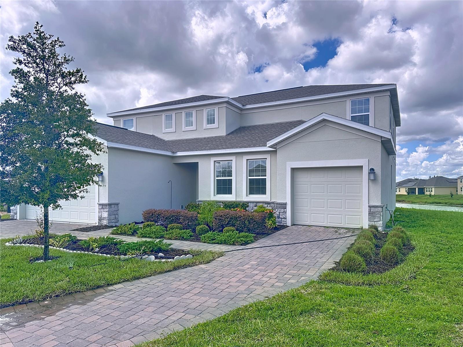 One or more photo(s) has been virtually staged. Beautiful waterfront home with a navigable canal right in your backyard. Perfect for caring for aging parents, hosting extended family, or creating a private space for a nanny, this Independence II Next Gen® design offers flexibility and comfort in every detail.
The home features six bedrooms, four and a half bathrooms, and three garages, including a separate garage that can be used as a gym, workshop, or additional storage. Spread over two stories, the floor plan provides everything your family needs with two full kitchens, two dining rooms, two family rooms, and a spacious lanai overlooking the water.
Located in the highly desirable Hanover Lakes waterfront community, this property sits on an oversized lot with endless potential. You can add a pool, build your own boat dock, or simply enjoy the peaceful water view. With direct canal access, boating, fishing, and enjoying nature are right outside your back door.
Hanover Lakes offers resort-style amenities including a dock and lift with access to the Chain of Lakes, a swimming pool with cabana, and a splash park for children. The community is conveniently located only 15 miles from Lake Nona Medical City and just 6 miles from the Florida Turnpike, providing easy access to shopping, dining, and local favorites such as the Harmony Farmers Market.
This home combines luxury, space, and convenience, making it the perfect place for your family to create lasting memories. Some photos are virtually staged.