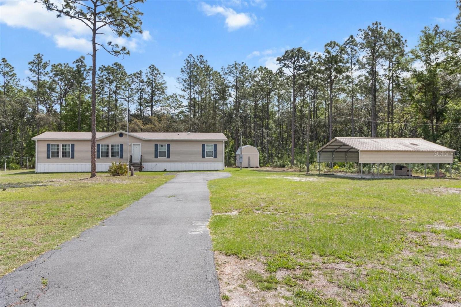 Welcome home to this stunning 2020 Clayton Destiny Model that offers everything you've been looking for—and more! Nestled on a sprawling 1.85-acre lot in the heart of beautiful Homosassa, this high and dry property boasts NO FLOOD and NO HOA, ensuring peace of mind and privacy. Step inside, and you'll be instantly impressed by the impeccable craftsmanship and thoughtful upgrades throughout. From the LVP flooring to the crown molding and everything in between, you will be pleasantly surprised. The spacious, open-concept kitchen with an island is a chef’s dream, featuring ample cabinetry and seamless flow into the dining area—great for hosting family gatherings or entertaining friends. French doors lead you into the family room, where natural light pours in, creating a warm and inviting atmosphere. Surrounding the family room are three generously sized bedrooms and a full bath, offering privacy and convenience. Laundry room is spacious and right off of the kitchen for easy access. Retreat to the master suite, conveniently located off the front living room, where you’ll find a sanctuary of space and comfort. The oversized walk-in closet provides abundant storage, while the master bath is designed for ultimate relaxation, featuring a deep garden tub, a separate shower, dual sinks, and plenty of cabinet space. With four bedrooms, two baths, and a wealth of thoughtful details, this home is ready to provide you with the lifestyle you deserve. Owner recently added a deck and a ramp to the front of the home! Approximately a 10 minute drive to the Homosassa River and 20 minutes to the town of Crystal River. Drive 10 minutes east to jump on the Suncoast Parkway for easy commute to Tampa. Don’t miss the chance to make this beautiful property your forever home!
