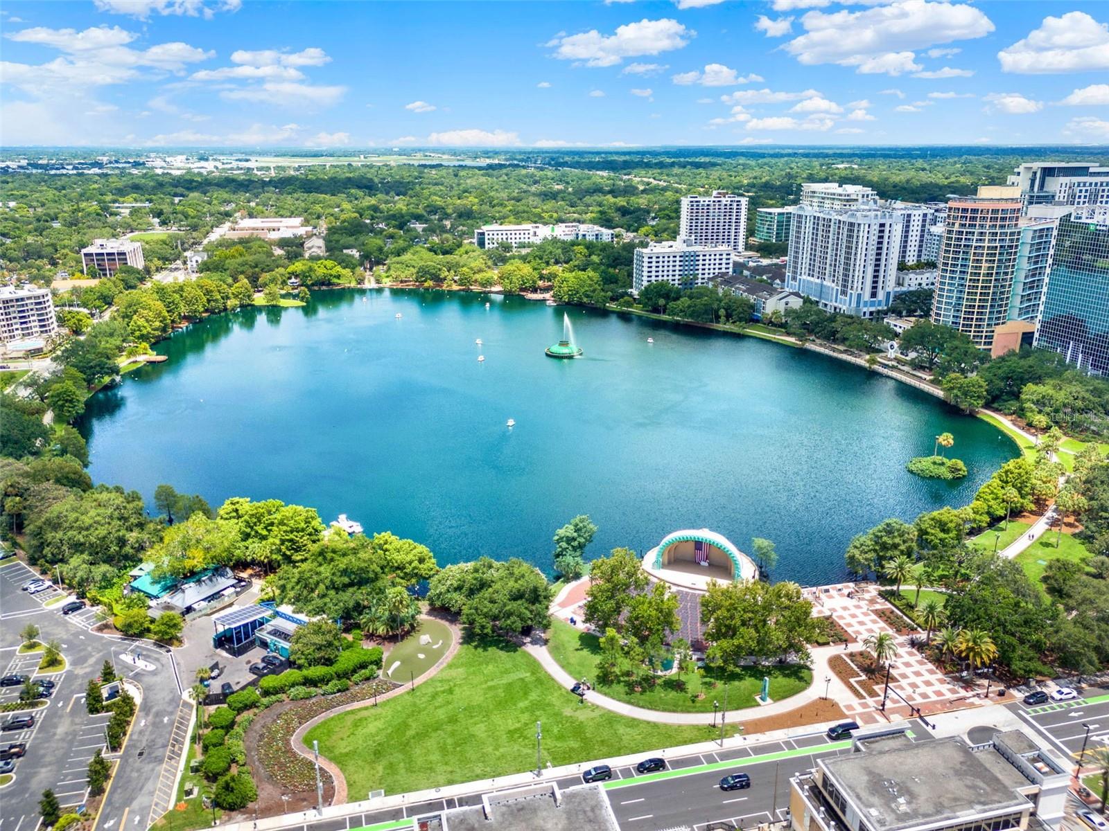 The best location and view in Downtown Orlando! You are in the middle of everything fun when you live here. Huge balcony for entertaining and relaxing. This unit overlooks the pool, Lake Eola, and the City skyline. Walk to all the fantastic events, parks, and superb dining. Dr. Phillips Performing Arts Center, SunRail, Orlando Library, and Orange County Courthouse and municipal buildings are all within walking distance. The condo has been freshly painted and has new appliances. It has the coolest washer/dryer combination, saves space and energy! The utility bill is super low because the association pays for the water, cooling/heating, garbage, and sewer. Solid concrete floors and walls, so you never hear a neighbor. This condo comes with TWO DEEDED PARKING SPACES. Huge community room and mailroom with secure package storage. It is a full gym, not just a fitness room. Yonder out by the pool and enjoy lounge chairs and a cabana bar, all overlooking Lake Eola. Owner is motivated. Easy to see, easy to enjoy!