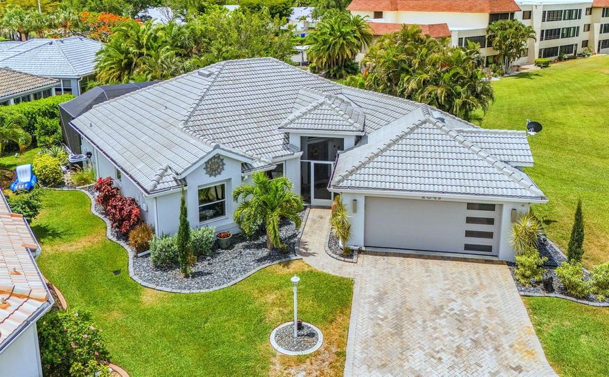 Beautifully updated and thoughtfully improved, this stunning 3 bed, 2 bath pool home delivers exceptional style and value at an attractive price point. Designed for effortless open-concept living, the light-filled great room seamlessly connects the living, dining, and kitchen spaces. Notice the wonderful natural light and tropical views from all the new windows and sliders. The redesigned kitchen features a wide granite breakfast bar, abundant counter space, custom cabinetry with pull-out shelving, premium KitchenAid stainless appliances, and striking wood-plank tile flooring. Whether preparing an intimate dinner or entertaining a crowd, this space was designed to bring people together. The spacious owner’s suite offers built-in shelving and a beautifully remodeled ensuite bath with gorgeous vanity, composite  counter, backlit mirrors, and a stylish walk-in shower. Sliding doors lead directly to the lanai for access to the pool and outdoor living areas. A custom Florida room addition provides extra air-conditioned living space overlooking the pool, while the expansive covered lanai is ideal for entertaining in the shade. The custom gradual access pool entry creates the perfect place to relax in the water and stay cool under the sun. Major updates provide peace of mind, including hurricane-rated windows and sliding doors, newer roof, 2024 AC, 2024 water heater, RainSoft whole-home water filtration system, and smart phone integration for the AC system, pool, and security cameras. Move-in ready and loaded with upgrades, this home makes it easy to leave the cold behind and start enjoying the Florida lifestyle you’ve been dreaming about. And the Marina community makes it a smart investment. With immediate access to open water from wet and dry leased slips, you'll enjoy world-class boating and fishing year-round. Combined with 27 holes of Golf, a vibrant Activity Club, Freedom Boat Club, Tennis, Pickleball and Fitness Center plus 3 onsite dining options, you'll enjoy a lifestyle secure behind the gates and filled with active, friendly neighbors to meet. Why wait?
