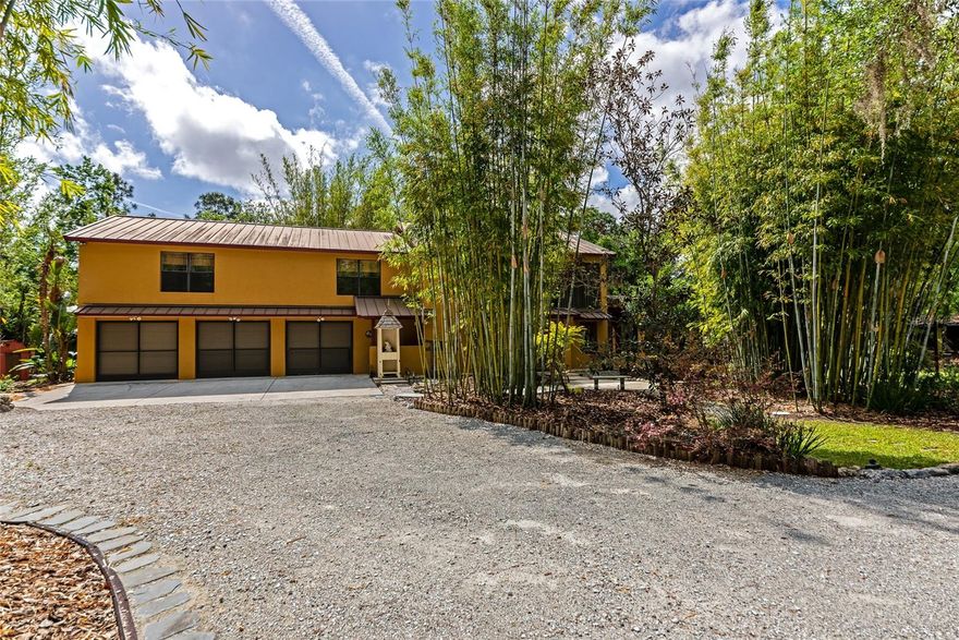 Welcome to a truly One Of A Kind estate in the highly sought-after Sundance Community where privacy, resilience, and natural beauty come together on over 5 serene acres. This 3 bedroom, 3 bath home is not just a residence, it’s a fortress built for peace of mind. Constructed using the IMF Styrofoam block system, the home boasts an impressive 200 mph wind resistance and an R-56 insulation rating, delivering exceptional durability and energy efficiency. Reinforced with engineered I-beam trusses, enhanced load-bearing support, and topped with a standing V-seam metal roof, this house was built to stand strong, making it feel like your own family hurricane shelter.

As you approach, you will immediately notice the sense of seclusion. The property welcomes you into a peaceful, private retreat, securing you in as you cross a private bridge. Lush bamboo gardens and a rich variety of subtropical plants create a setting that feels like a botanical escape with walking paths and wooden foot bridges. Adding to the tranquility, a river winds through the wetlands portion of the land, visible through a backdrop of mature forest. This natural barrier not only enhances the beauty but also provides exceptional privacy from neighboring areas. A natural earth pond rests beside the 250 foot long private driveway. It welcomes in a delightful variety of native owls, hawks, deer, and other habitat; all adding to the charm that living on untouched “Old Florida” property offers. The unique blend of uplands and wetlands creates a peaceful, campground like atmosphere across different areas of the property, an uncommon serenity that’s hard to replicate.

Functionality meets flexibility throughout. A large portion of the acreage is already cleared and usable, featuring multiple sheds, a 4-car carport, and abundant storage options. The attached oversized 3.5 car garage, also constructed from the IMF Block, is built extra deep, offering valuable flex space perfect for a home business, workshop, craft area, or future climate controlled expansion. Outdoor living is just as impressive, with two screened lanais, an open-air balcony, and an extended patio space designed for relaxation, entertaining, and soaking in the surrounding nature. It’s the kind of property where every day feels like a getaway. Located within Sundance, residents enjoy a rare combination of freedom and amenities. The community allows for home-based businesses and horses, and offers access to a marina and stables all with minimal restrictions and an incredibly low HOA fee of $220 per year. If you’ve been searching for a property that offers strength, space, privacy, and a deep connection to nature ... this is it.