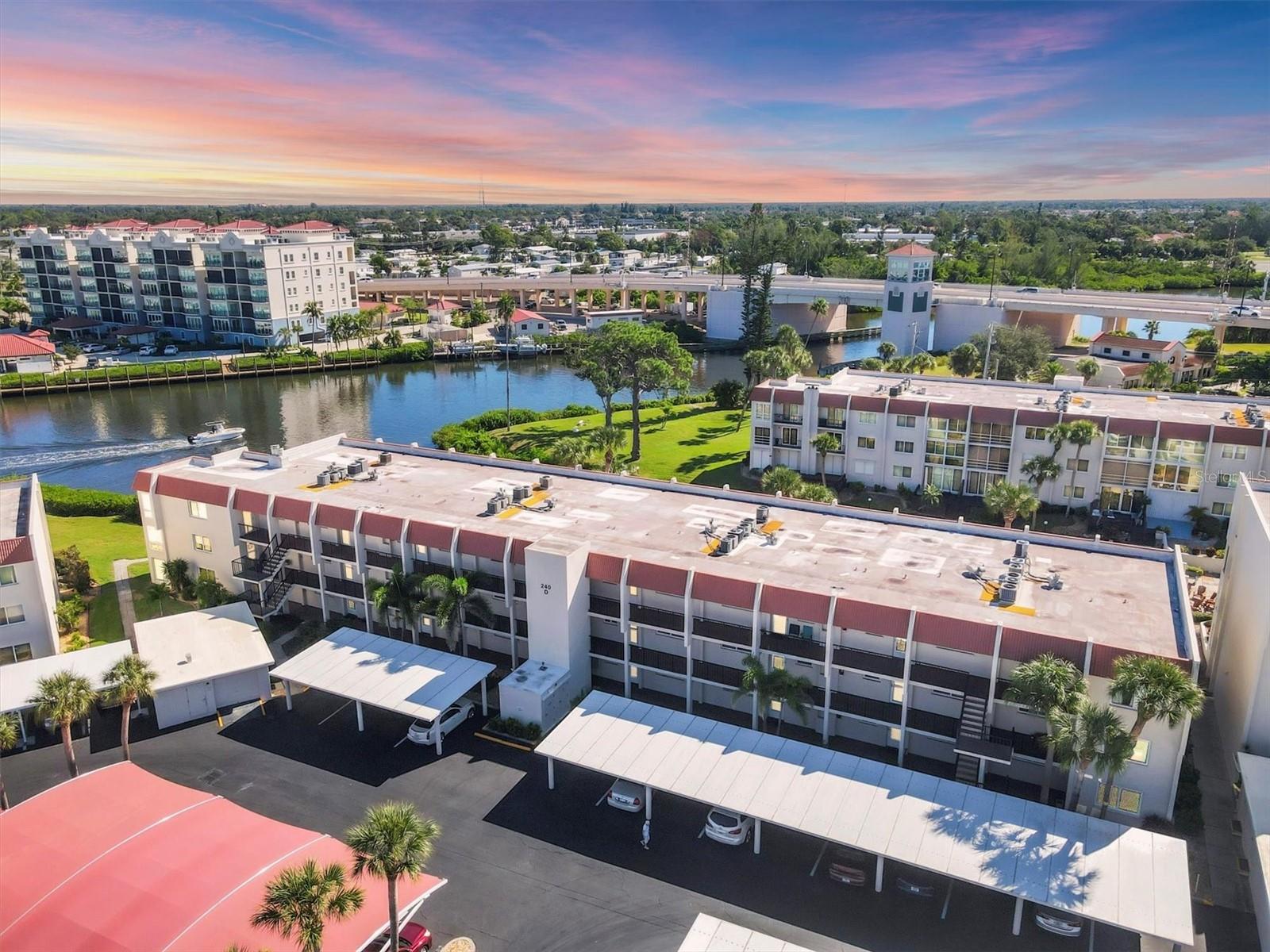 Exceptional third-floor condominium on Venice Island, beautifully designed and appointed residence offers glistening water views and a luxurious coastal living experience! Fully renovated in 2018, this waterfront retreat features high-end finishes throughout, including luxury vinyl plank and tile flooring, stunning Taj Mahal Quartzite natural stone countertops, custom window treatments, and elegant nickel slot finish ceilings complementing the coastal style decor and trim throughout. Enjoy the best of Florida living as you are drawn to the serene boat basin vistas visible from the great room and inviting sitting area. The gourmet kitchen features tray ceiling, gorgeous quartzite countertops, Shaker-style cabinets, a stylish tile backsplash, and top-of-the-line stainless steel appliances, including a Bosch dishwasher. The two spacious bedrooms each boast walk-in closets and ensuite baths, complete with Quartzite countertops, tiled walk-in showers, spot-resistant sliding shower doors, and premium Kohler plumbing fixtures, ensuring privacy and comfort. Additional significant updates include PGT impact resistant windows and sliding door, front exterior storm door, new A/C unit, hot water heater, electrical panel, and an interior stacked washer and dryer. The building offers an elevator, a new covered carport, and additional storage, making this a truly move-in-ready home. Bella Costa has successfully completed its recent MILESTONE inspections, demonstrating fully funded reserves with no structural deficiencies or pending assessments. Situated on the Intracoastal Waterway, Bella Costa provides a quiet sanctuary where you can relax and unwind, or enjoy the fantastic amenities, including a resident clubhouse with a heated pool, gathering room, fitness, sauna, billiards, and library. This prime location offers the perfect Venice Island experience. You'll be just two blocks from historic downtown Venice's acclaimed restaurants, unique shopping, Centennial Park, the lively Farmer's Market, and various events, and the inviting waters of gorgeous Venice Beach are just one mile away!